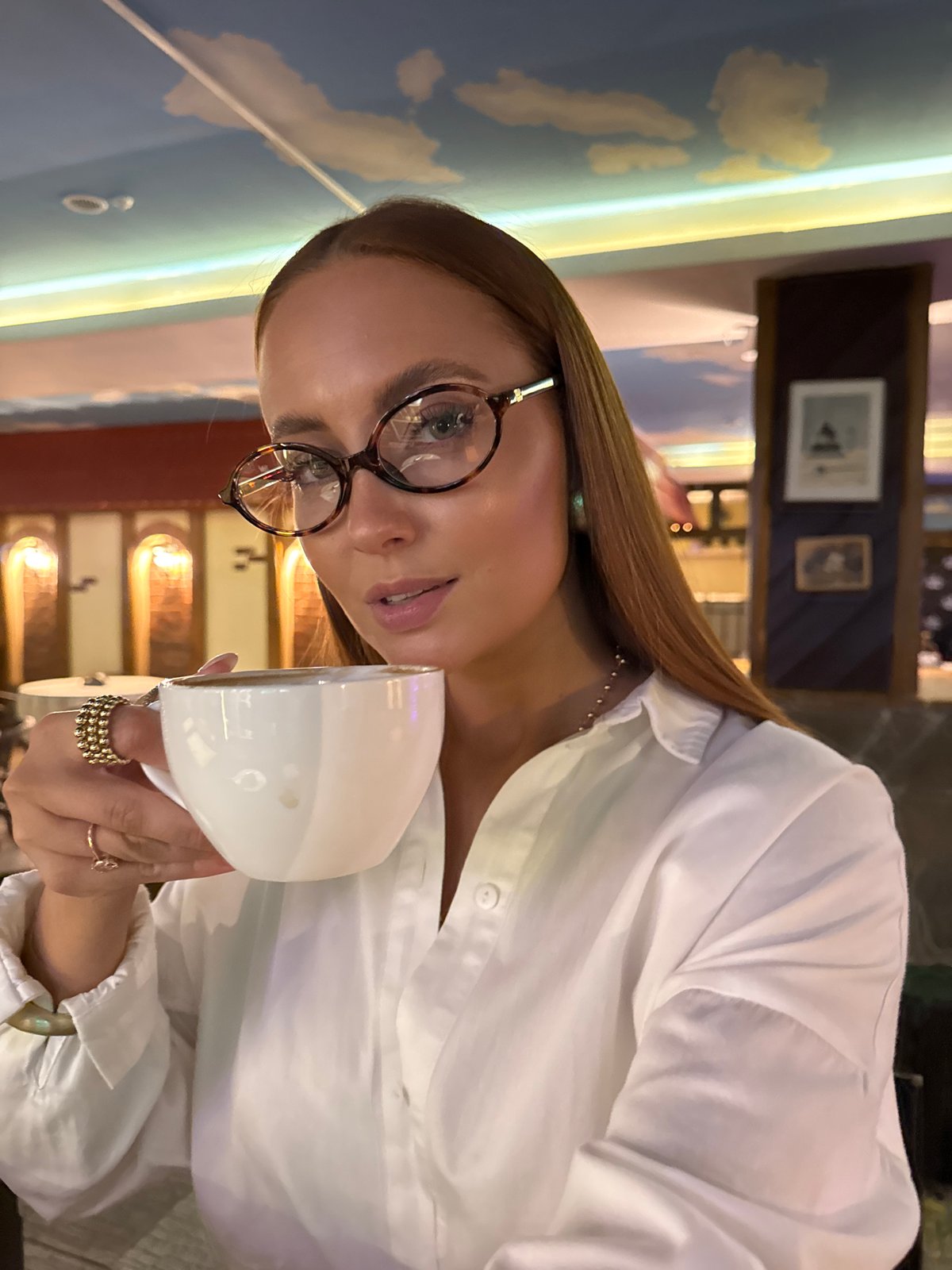 Woman enjoys coffee break at Chaikovsky café