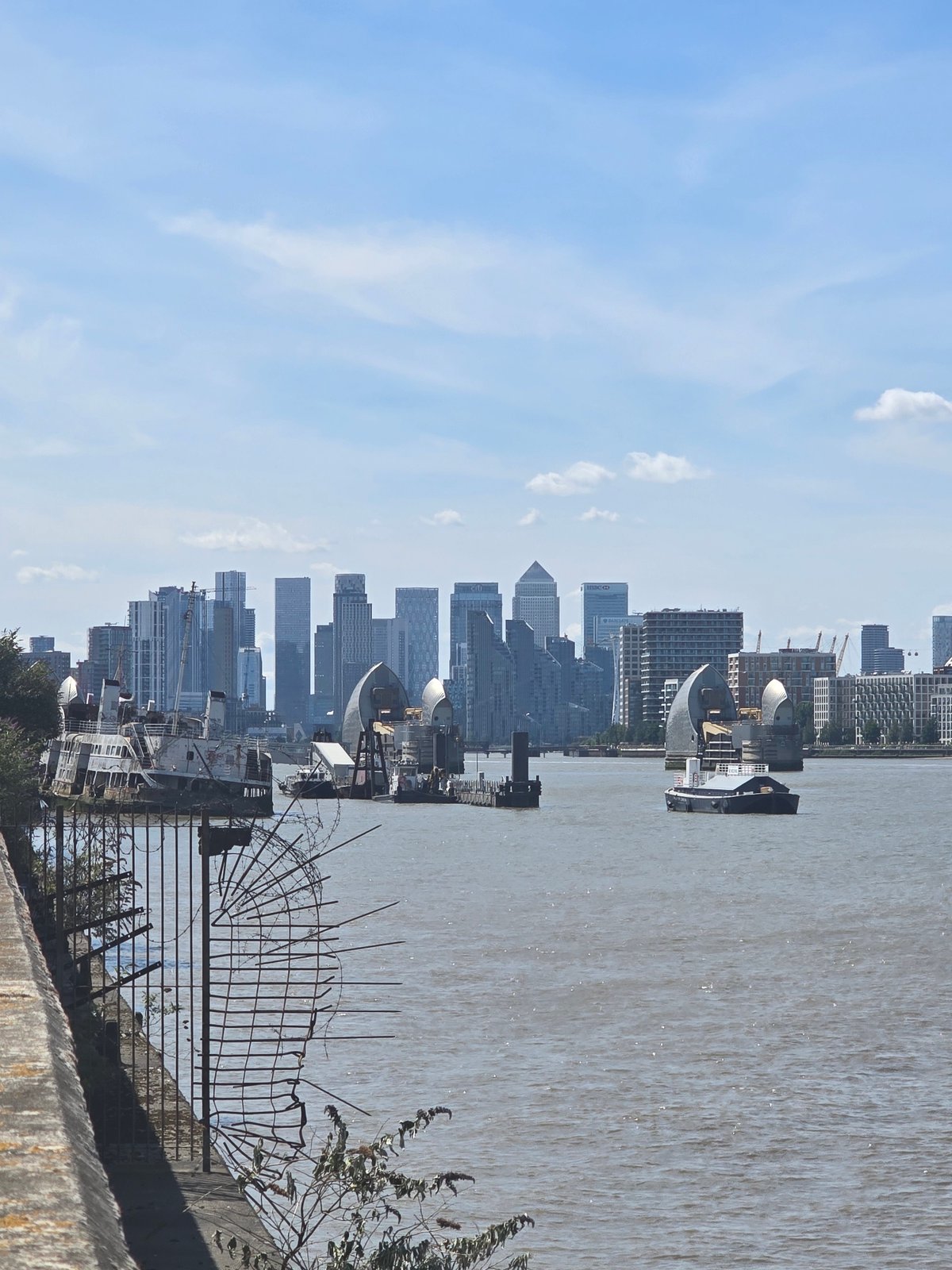 Thames riverbank view with Canary Wharf skyline behind