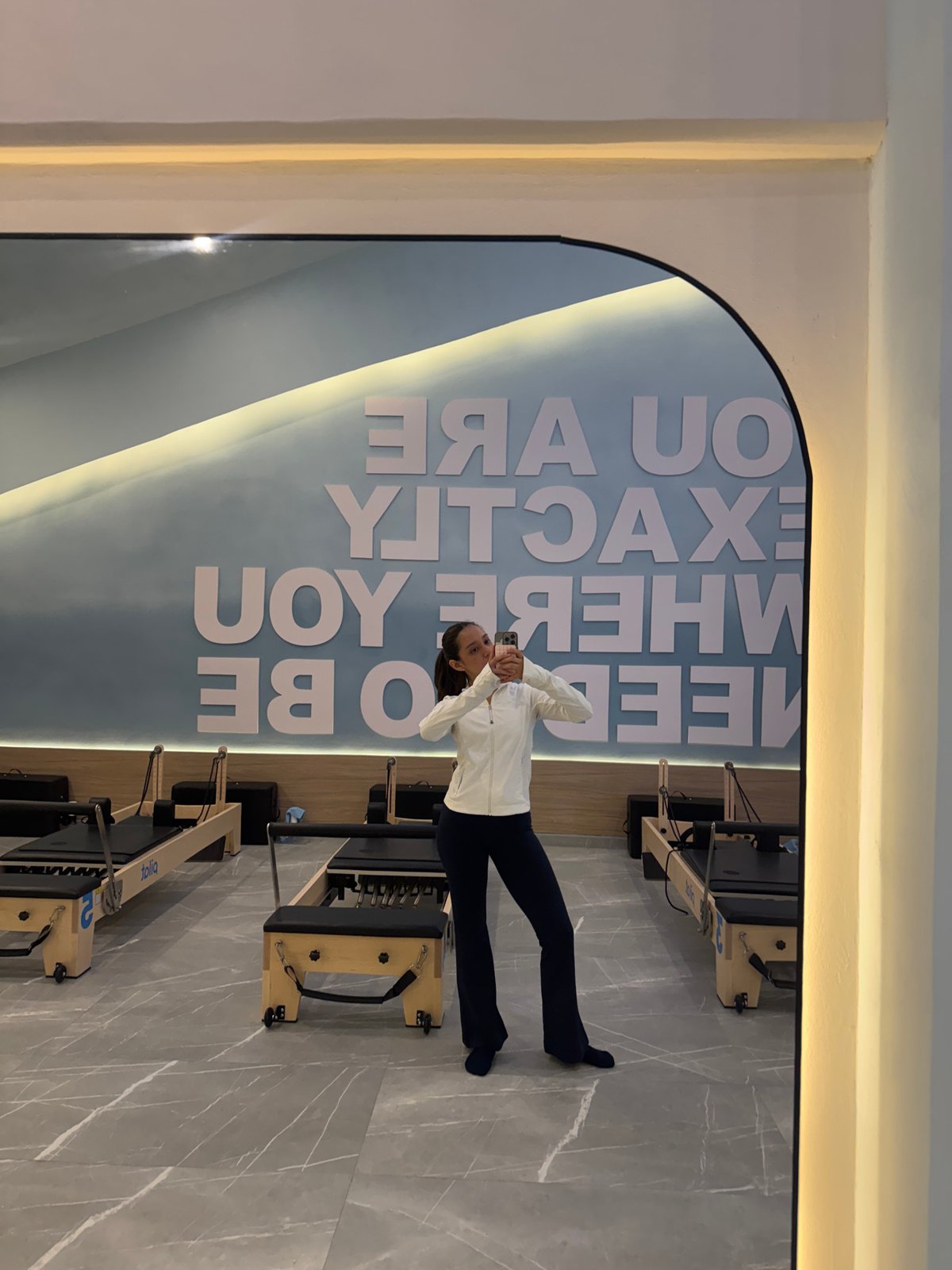 Mirror selfie inside a modern Pilates studio in Puebla