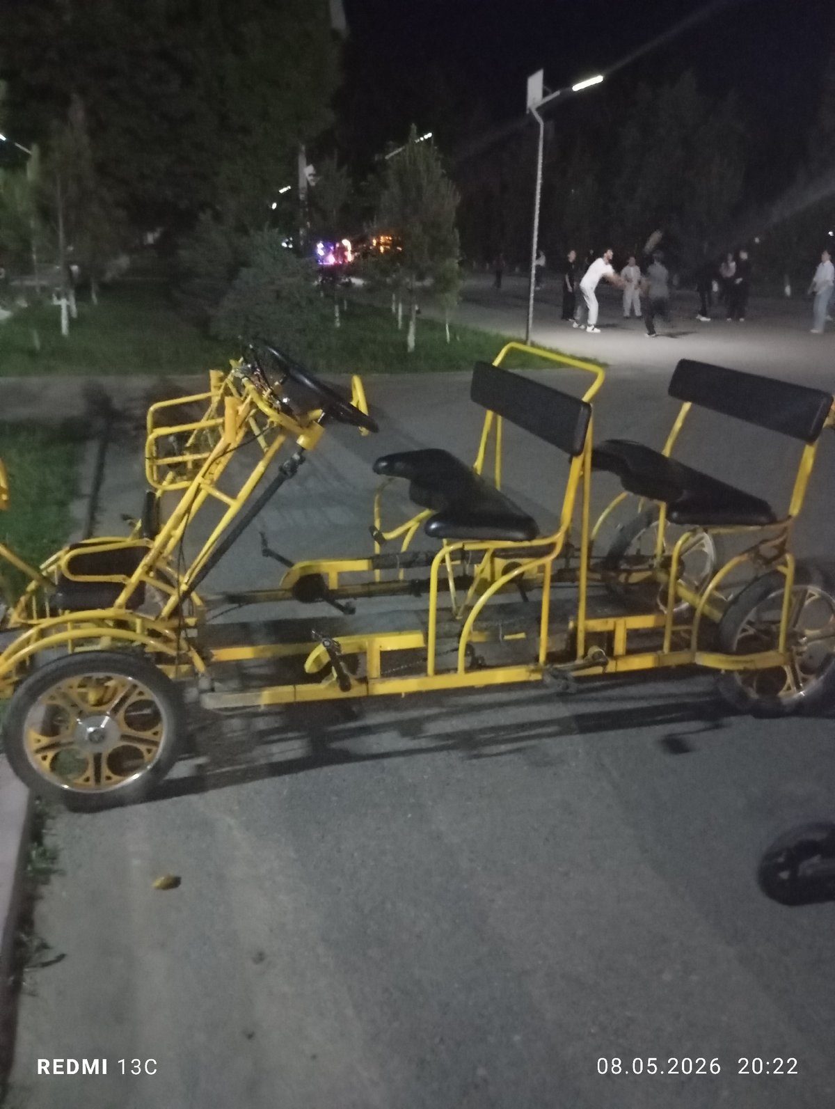 Yellow quadricycle spotted on nighttime street in Gazalkent, Uzbekistan
