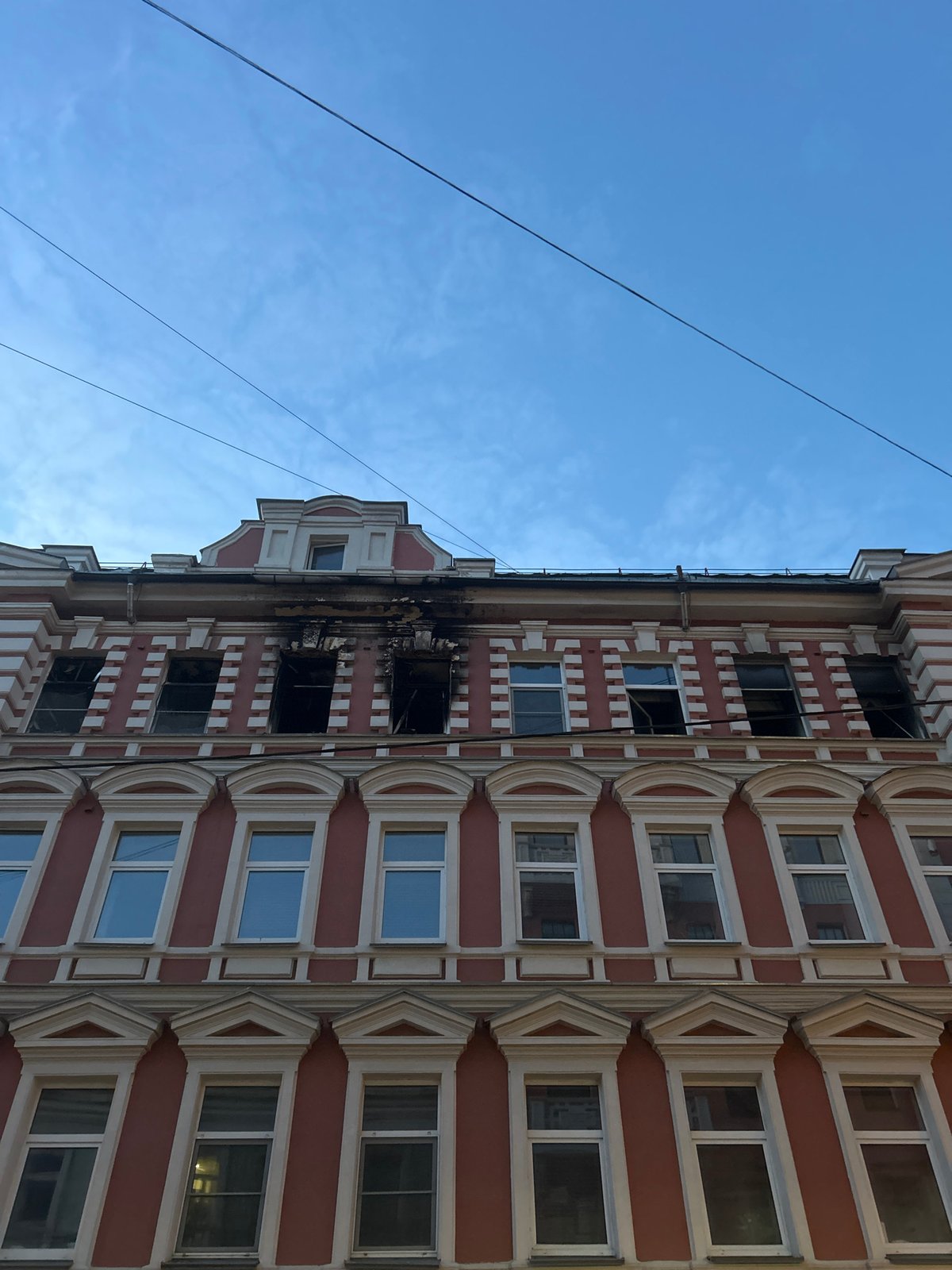 Fire-damaged ornate building photographed in Moscow