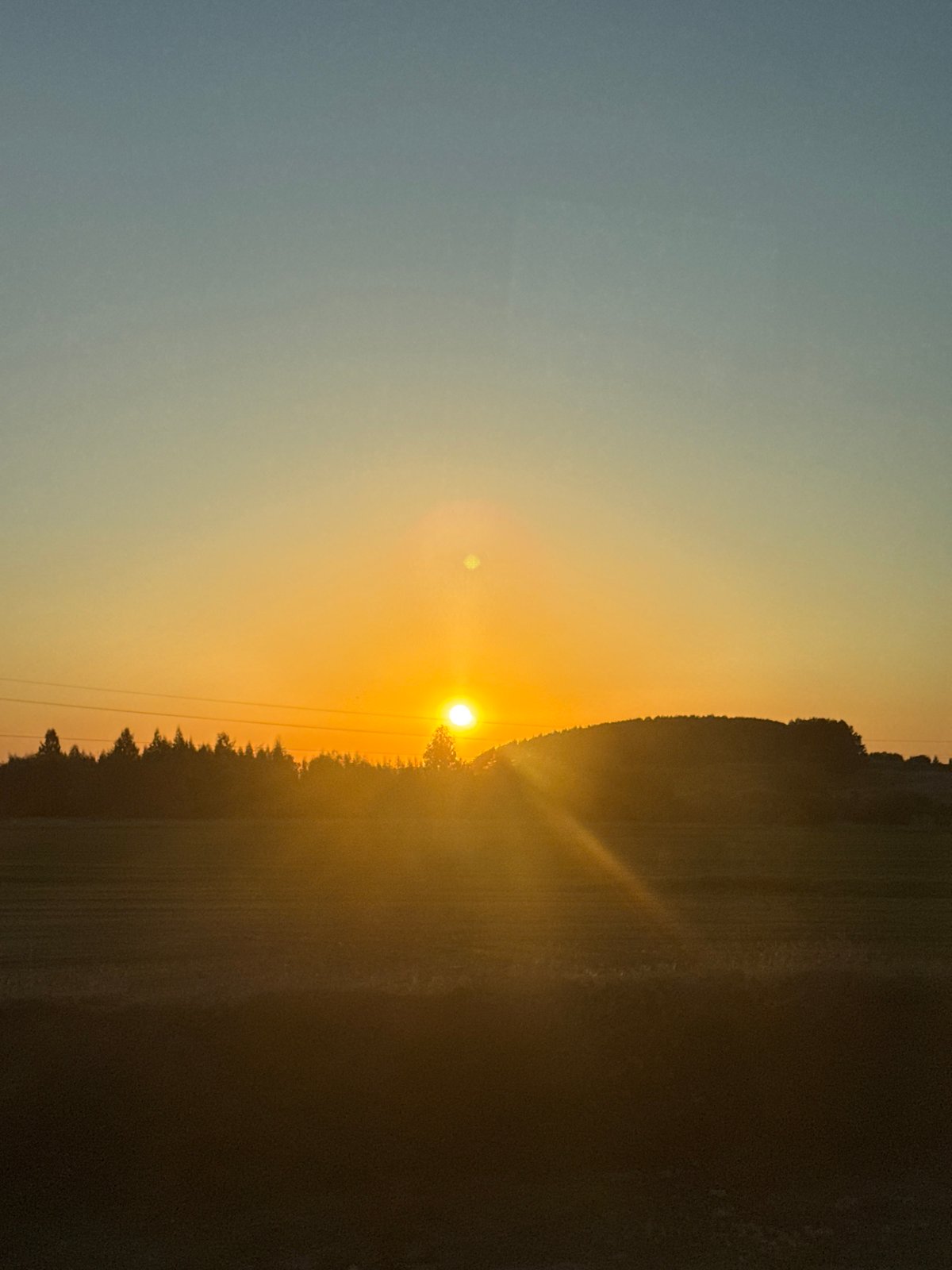 Sunset photographed through window in rural Russian village