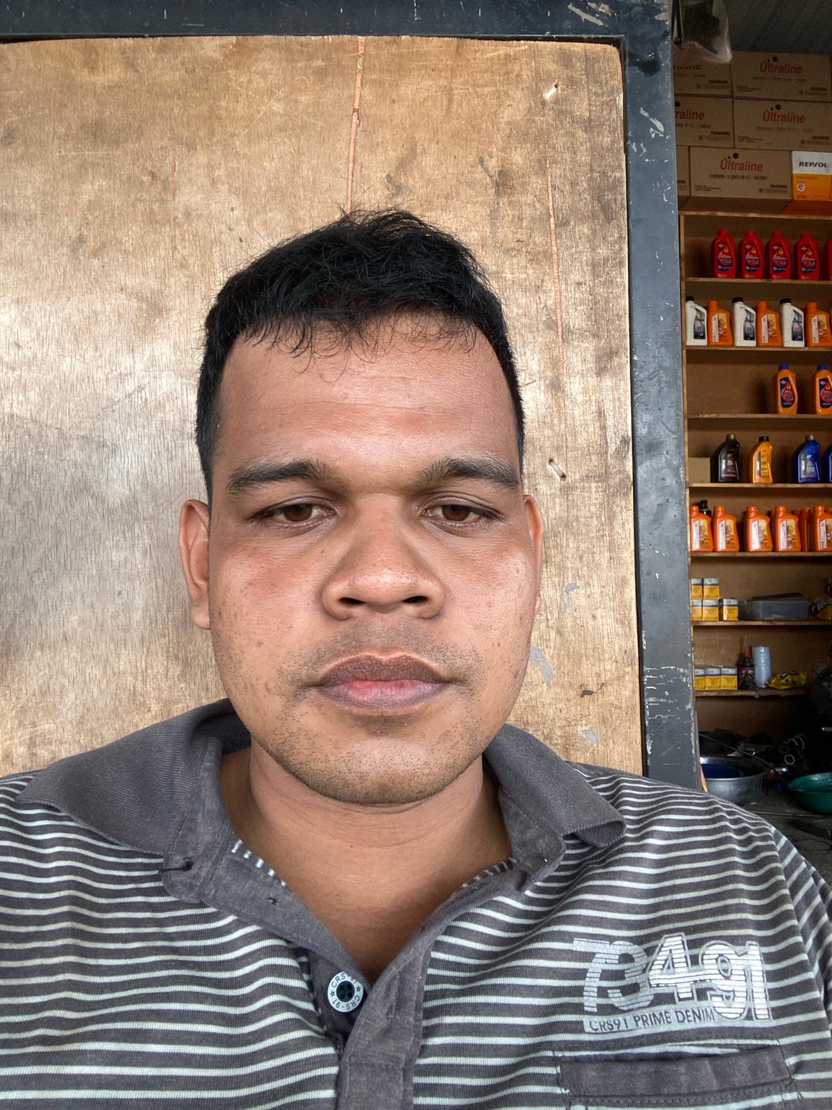 Roadside motorcycle workshop in full swing, Bayu, Indonesia