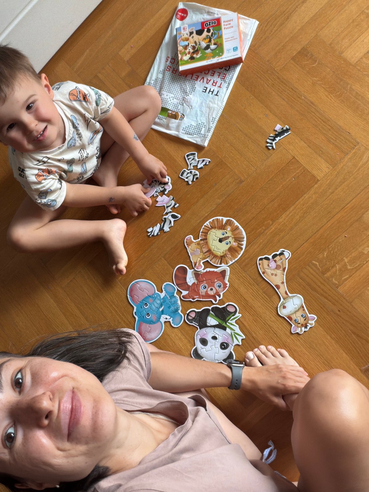 Mother and child work on animal puzzle in Budva