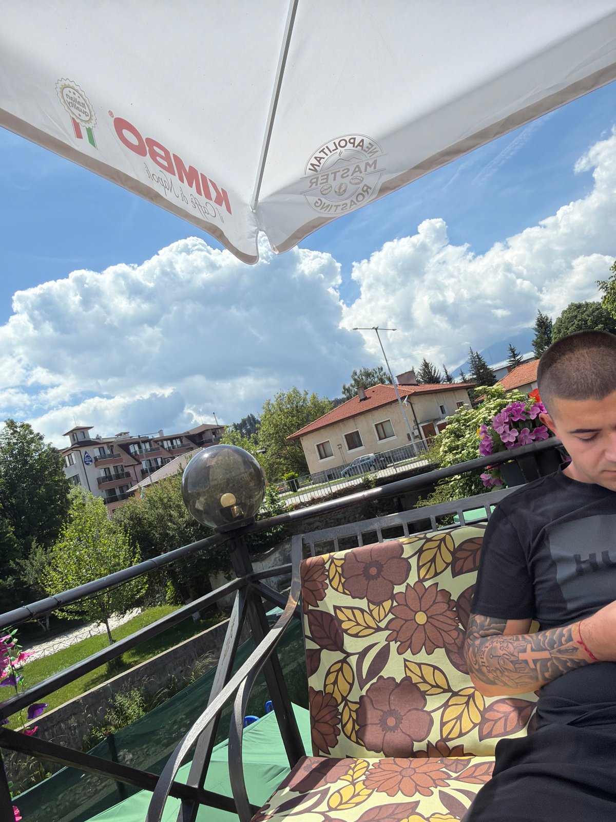 Young Man Photographed at Outdoor Cafe in Paris Setting