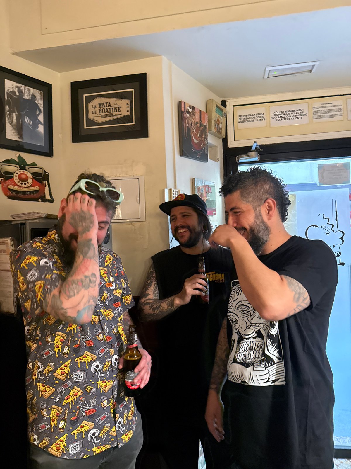 Tattooed friends socialize at Barcelona bar during afternoon gathering
