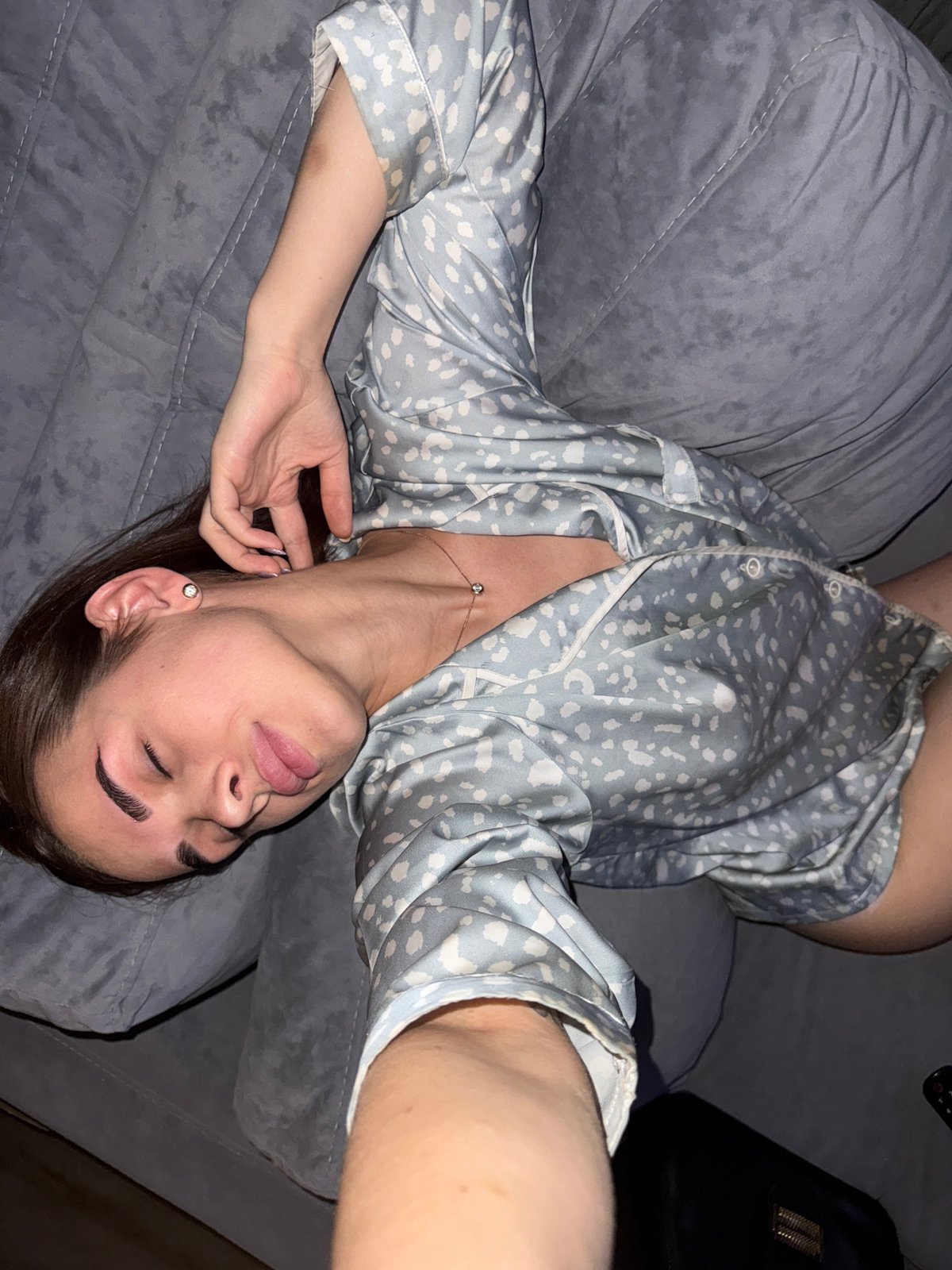Woman rests on couch watching medical TV in Лобаново