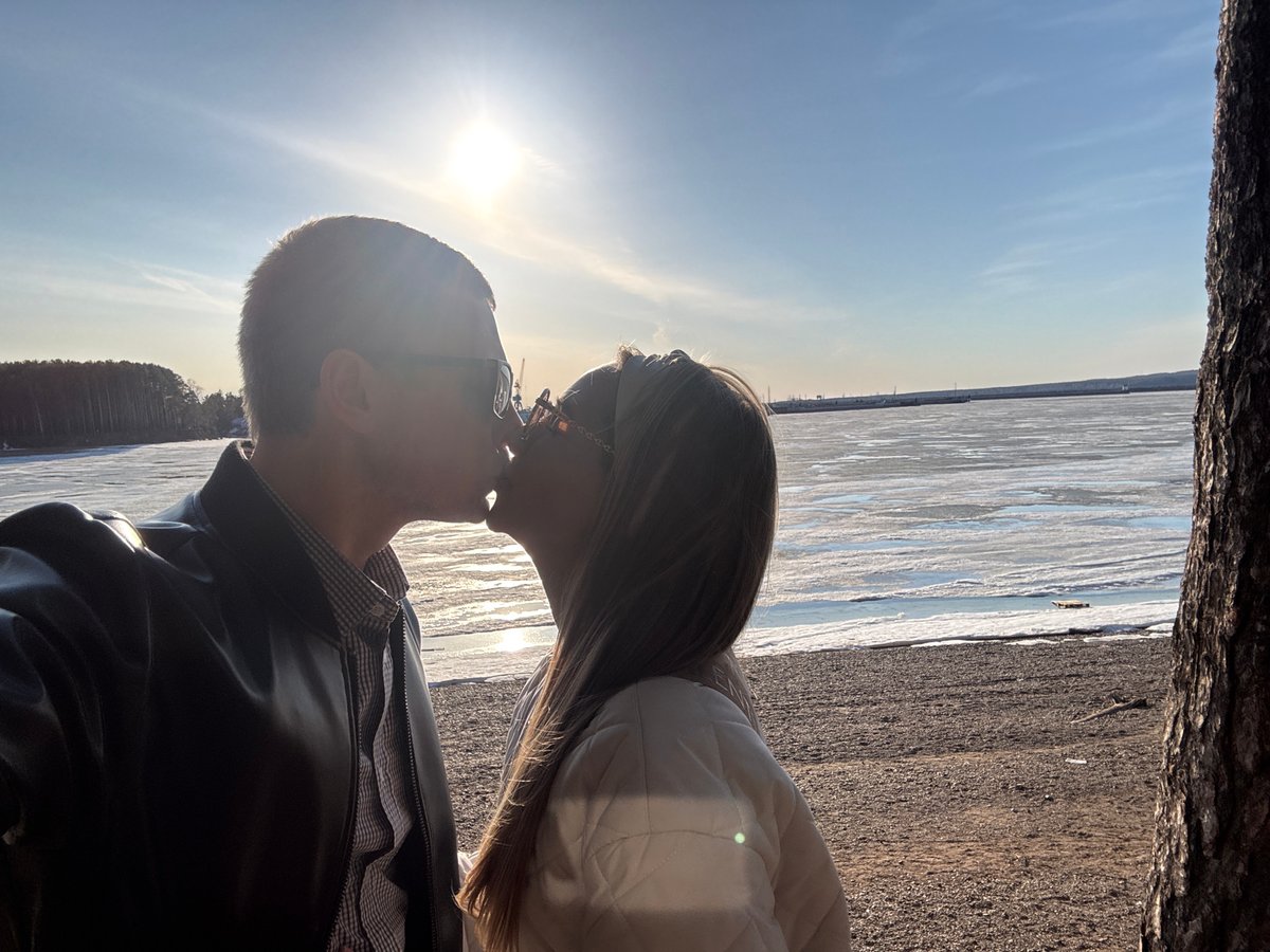 Couple shares romantic moments by frozen waterway in Chaikovsky
