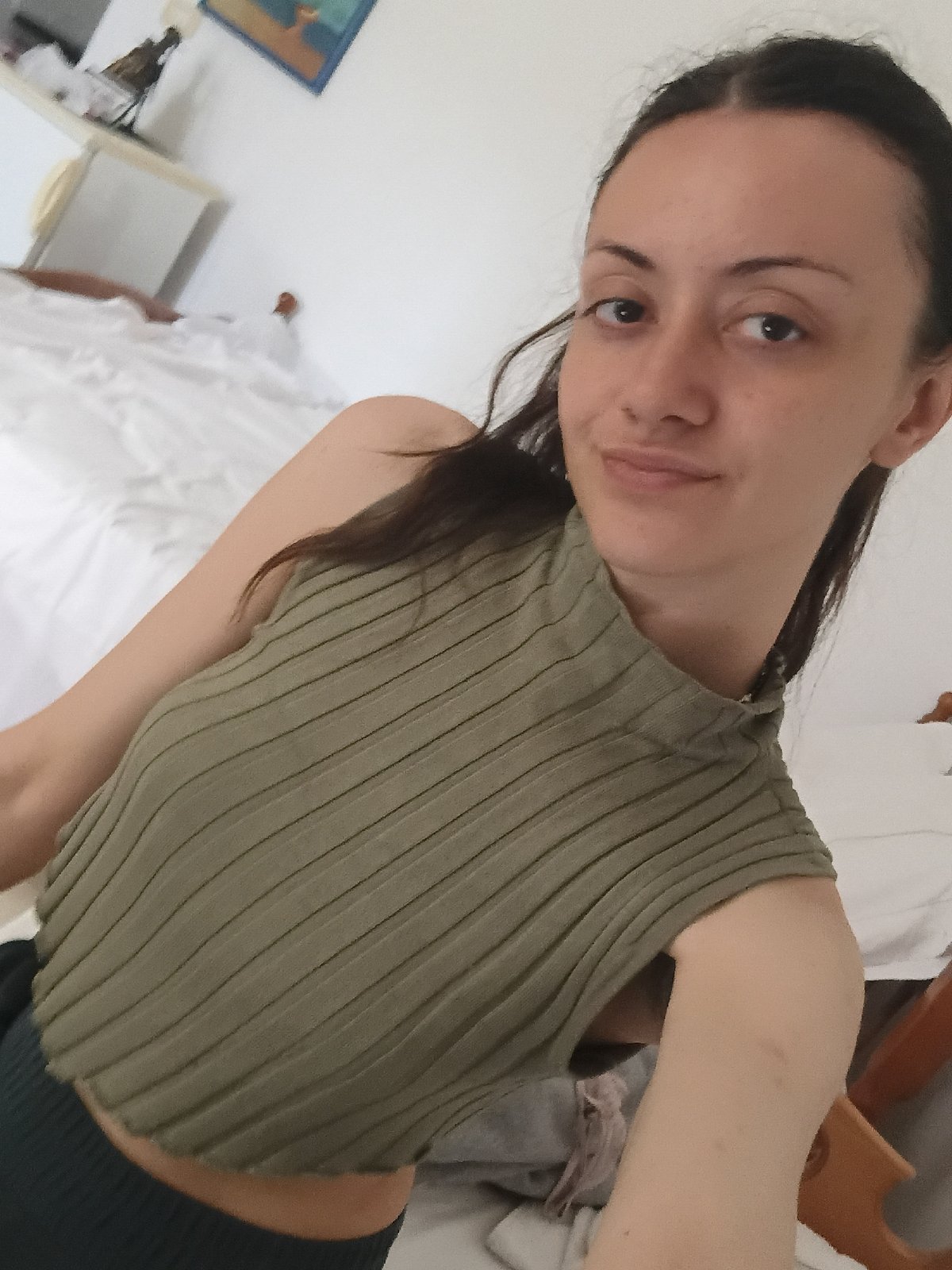 Woman takes selfies in green top in Vlora, Albania