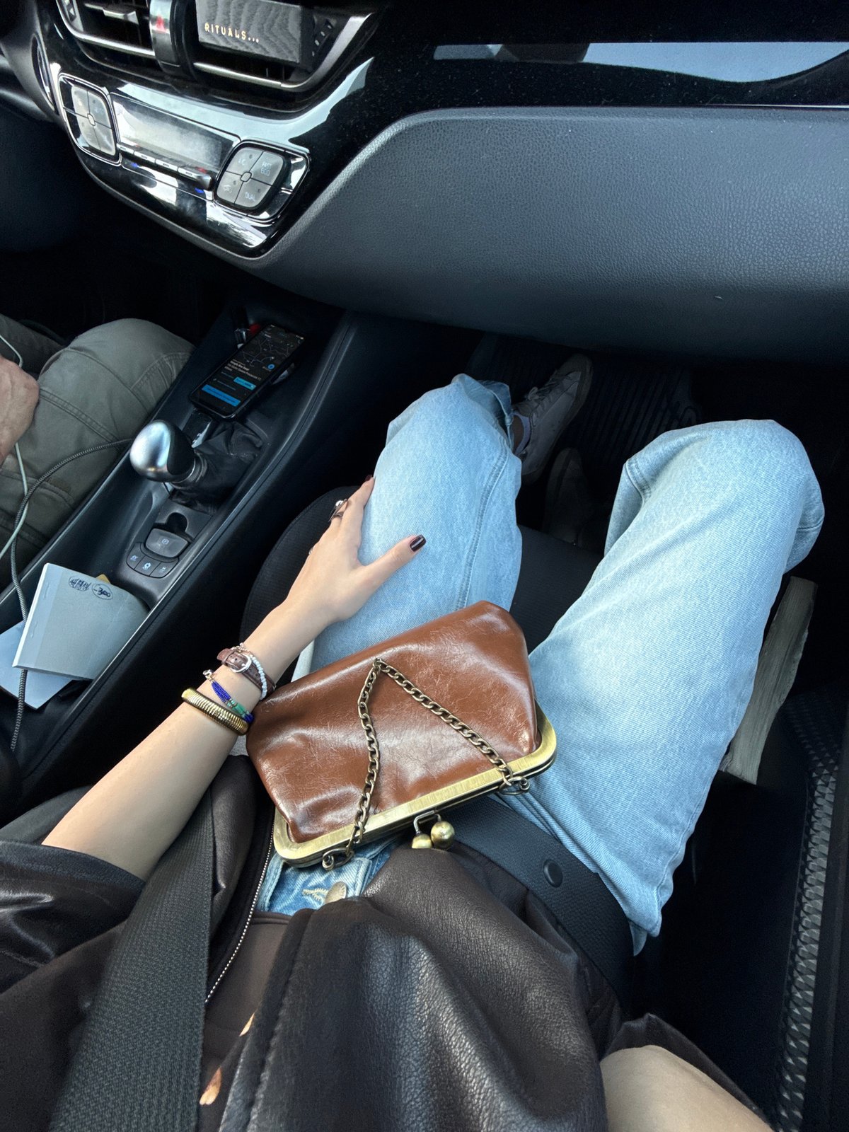 Person photographed from car interior on Milan street