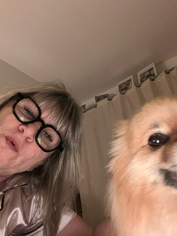 Woman documents bedtime routine with Pomeranian in French bedroom