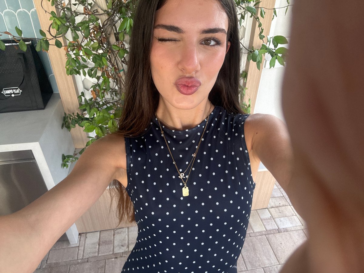 Outdoor patio photo session in a navy polka dot dress