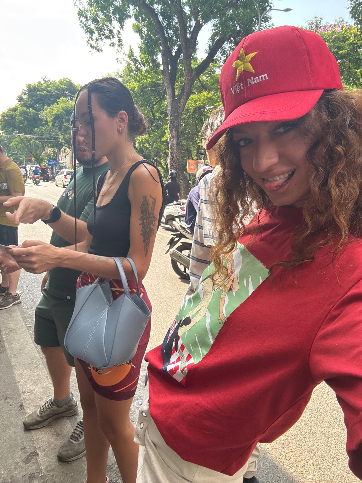 Woman in Vietnamese cap photographed smiling in Hanoi