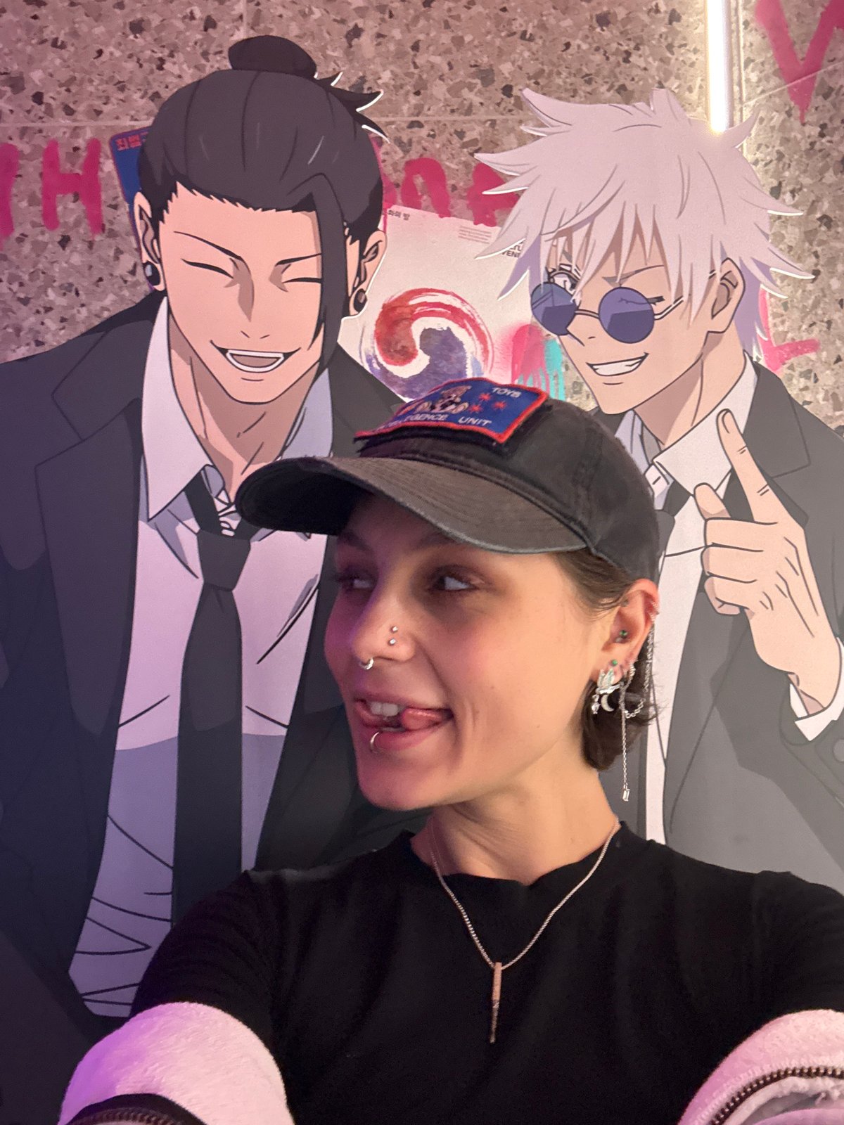 Person poses with anime character displays in Moscow interior