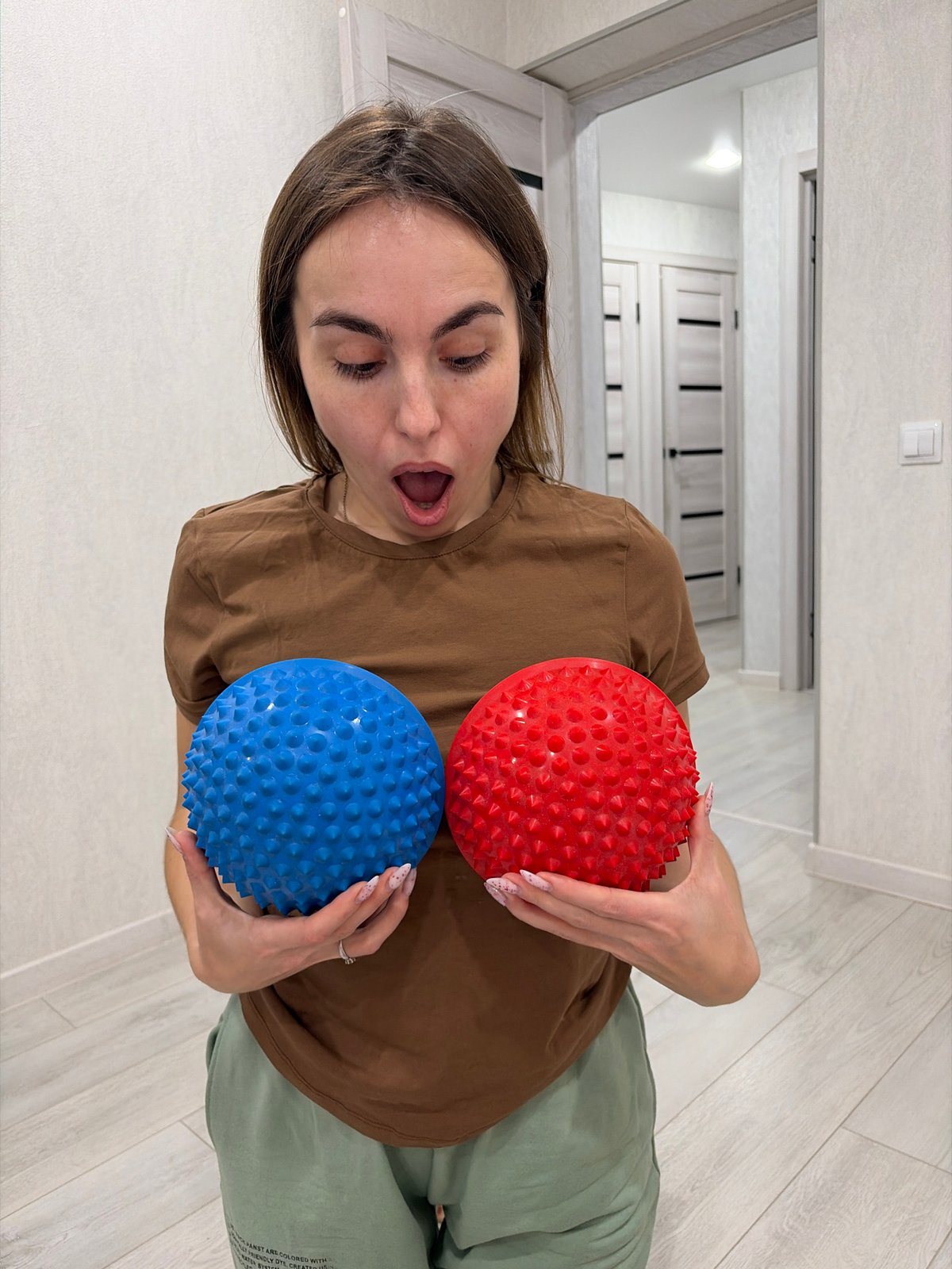 Woman uses massage balls during fitness session in Sarapul