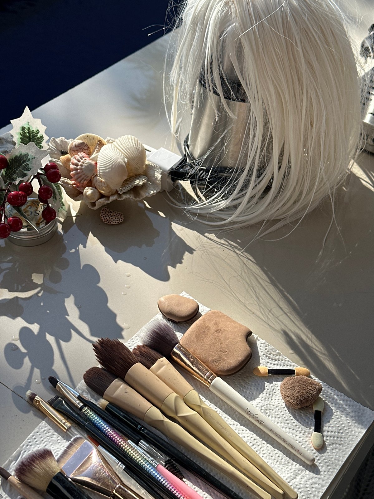 Makeup tools and a blonde wig laid out in North Kuta
