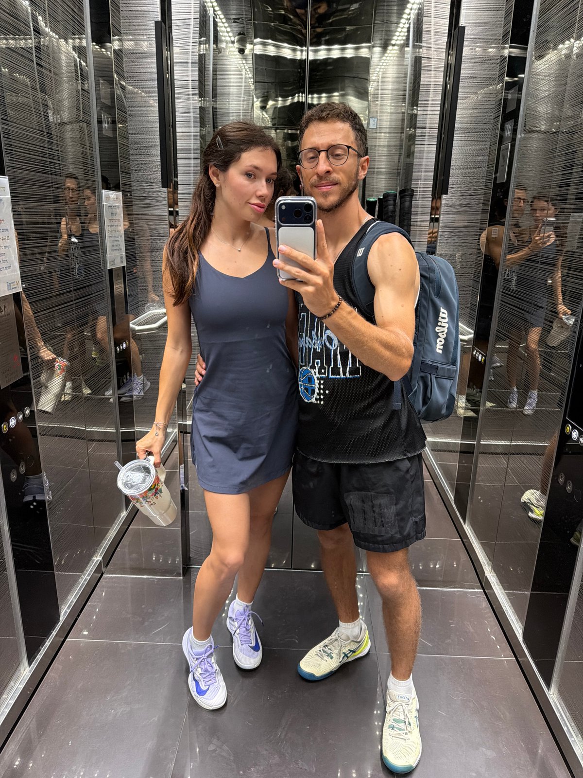 Couple Takes Selfie in Modern Mirrored Elevator