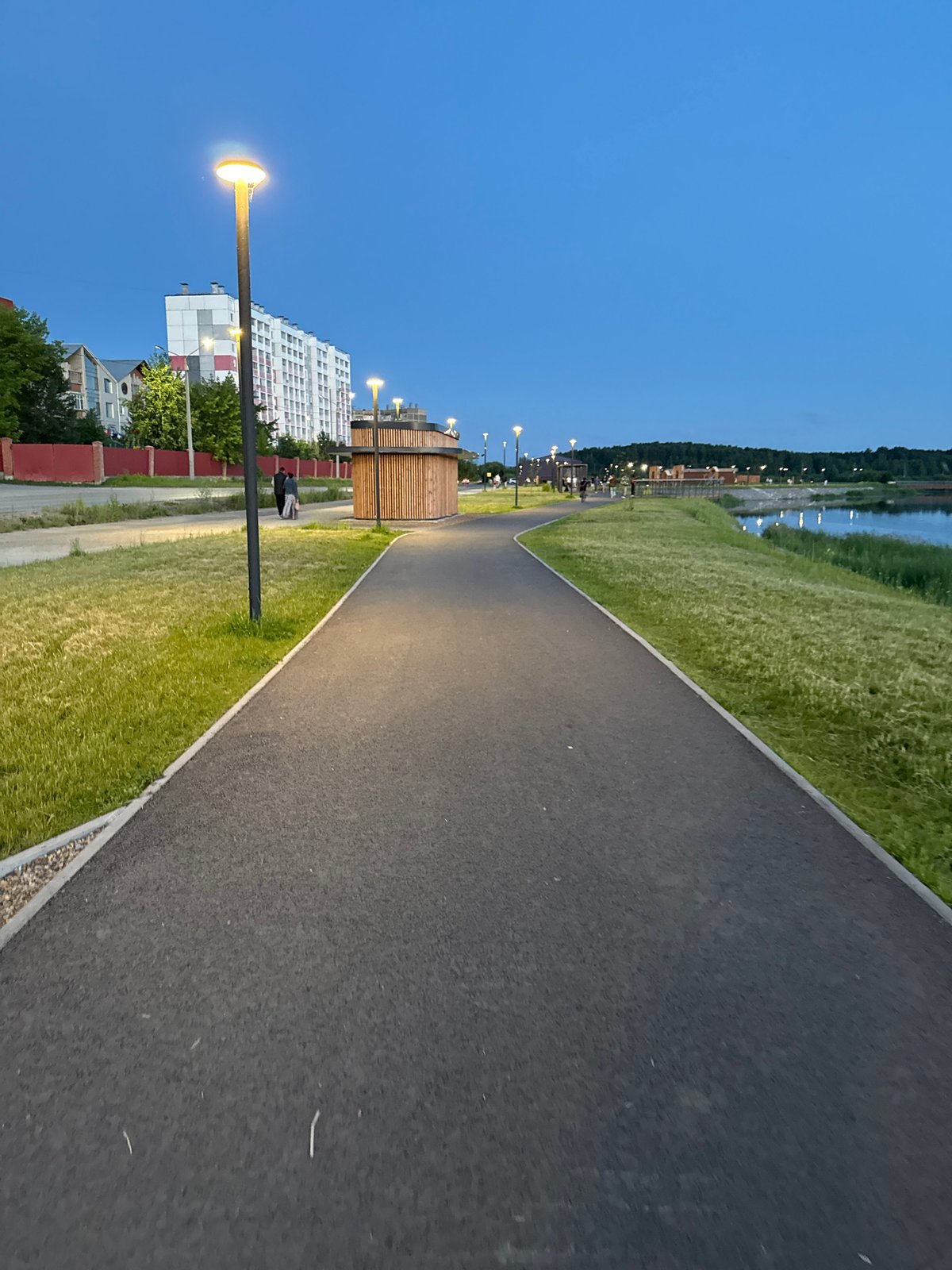 Summer evening along the Miass lakefront park and promenade