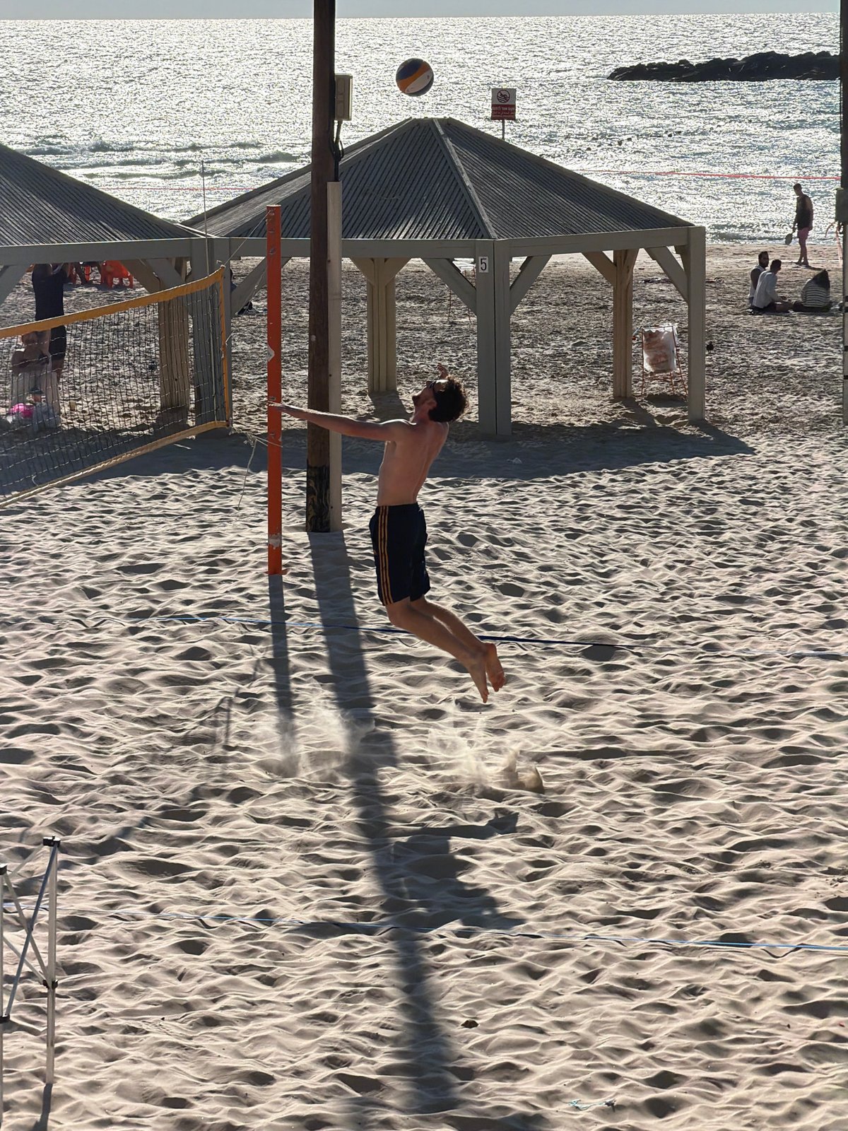 Tel Aviv beachgoers enjoy volleyball, kites amid sunny skies