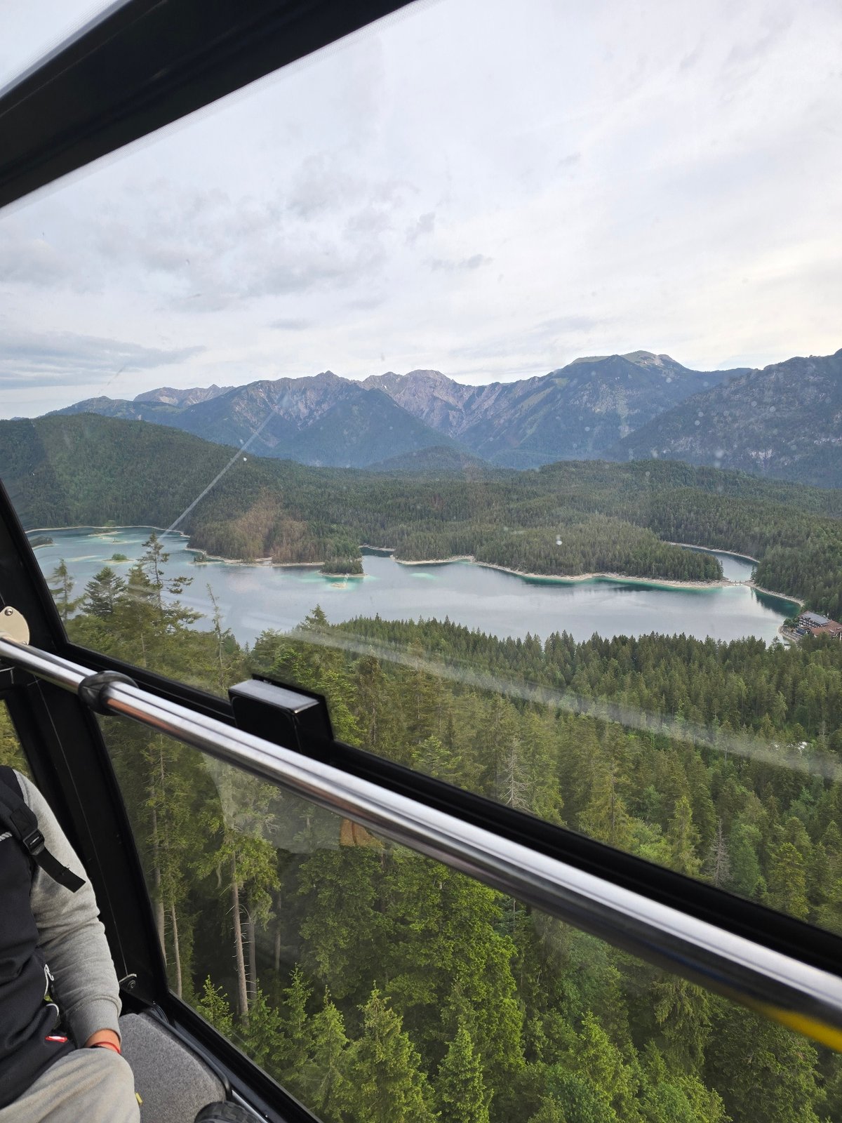 Cable car passenger photographs Eibsee Alpine landscape in Grainau