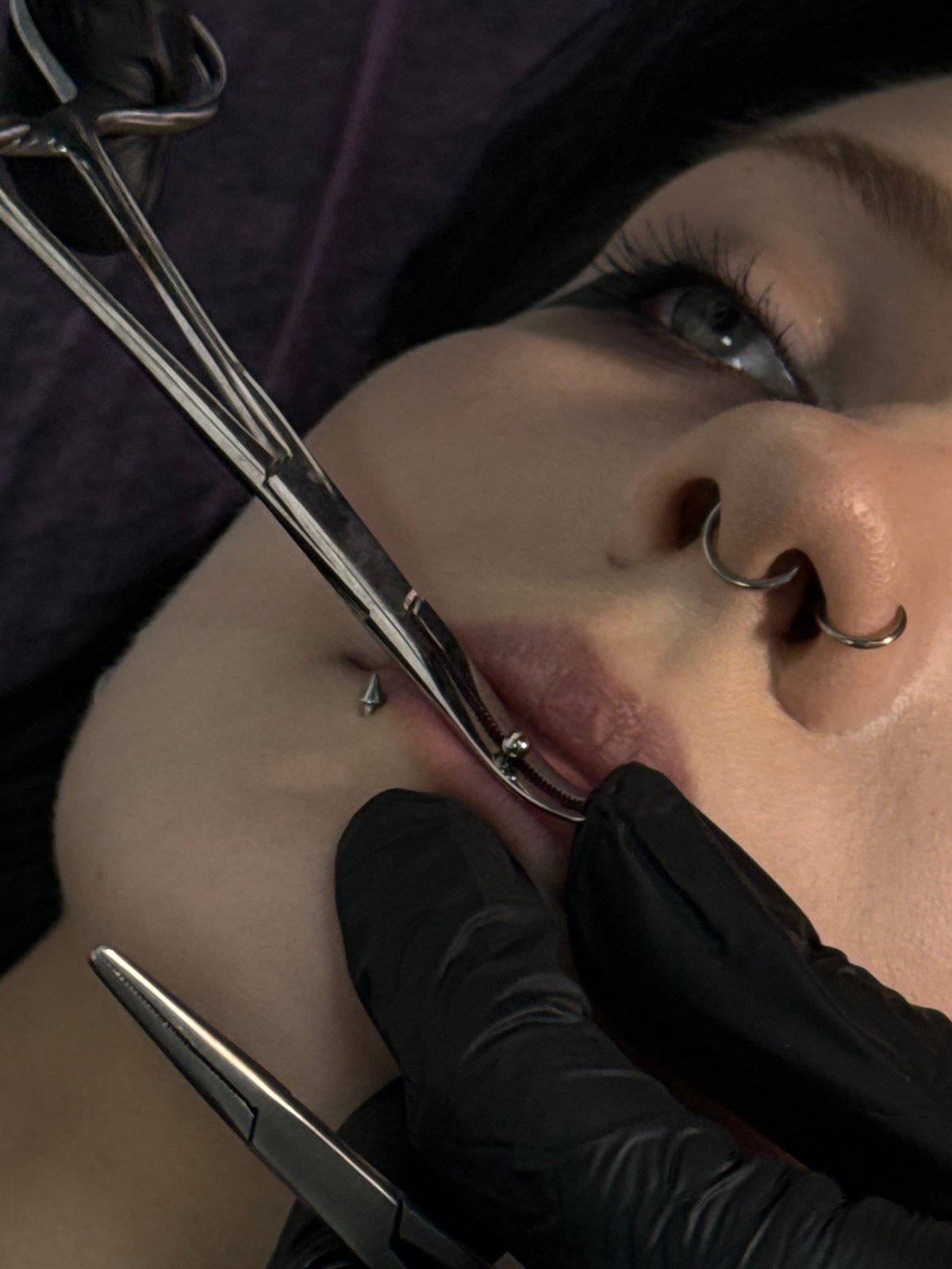 Woman receives lip piercing at Rostov-on-Don salon