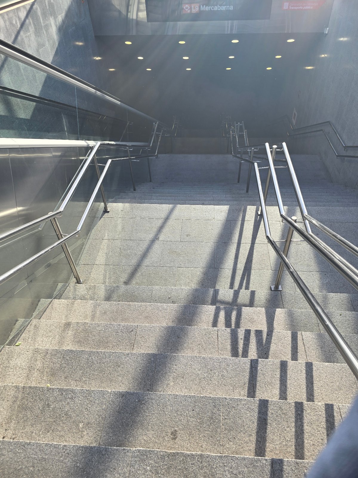 Empty Barcelona metro station staircase captured by witness
