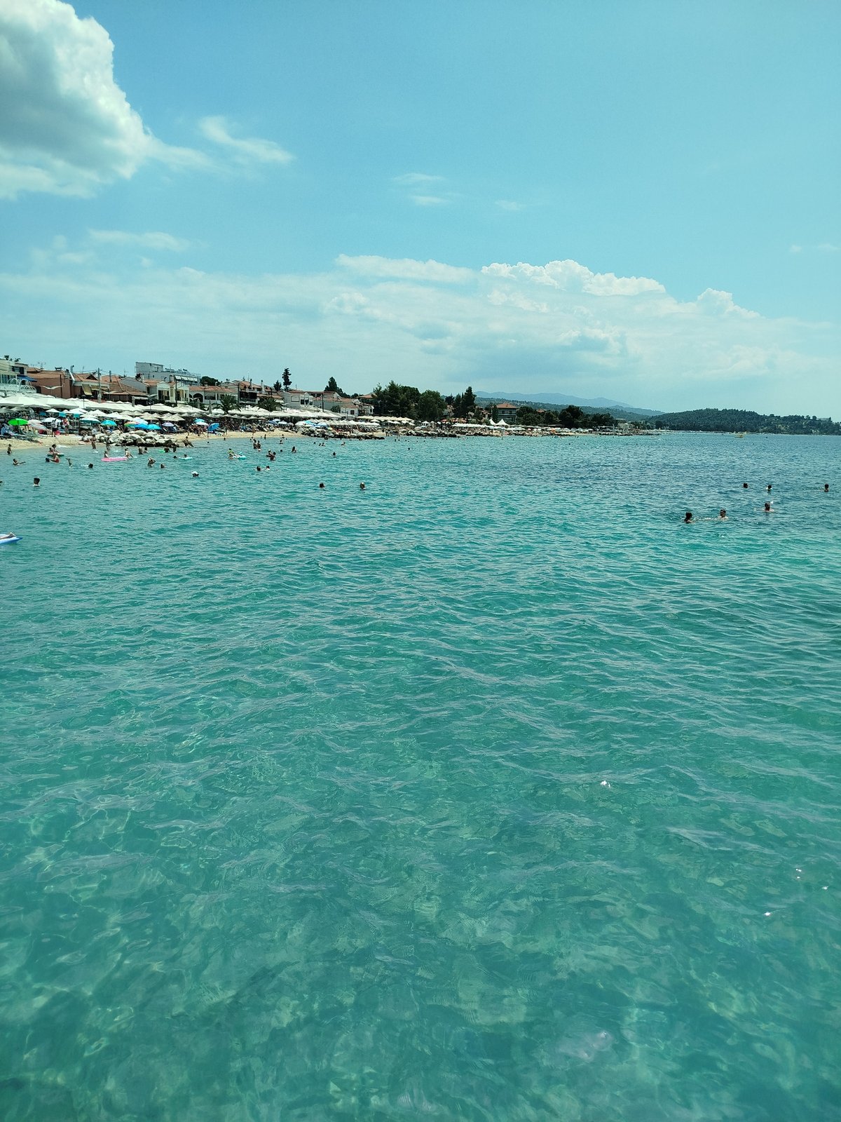Crowded summer beach day on the Sithonia coastline, Greece