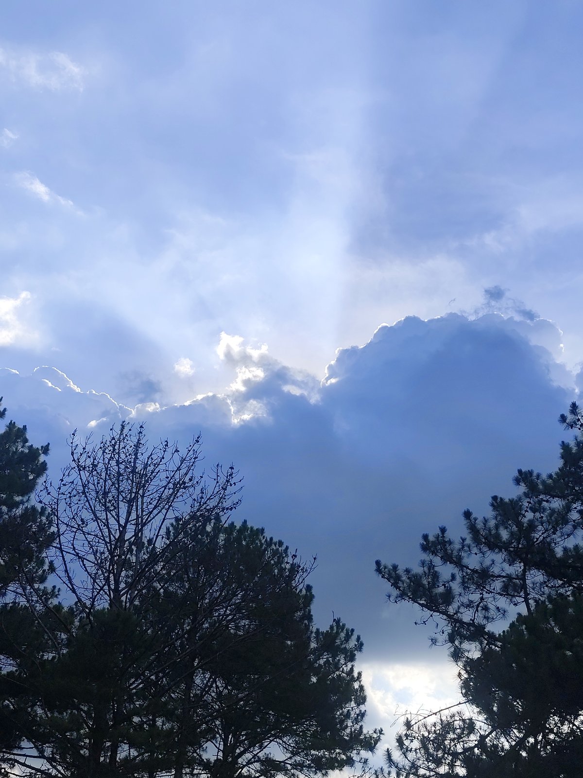 Sunbeams pierce clouds over Lạc Dương, Vietnam countryside