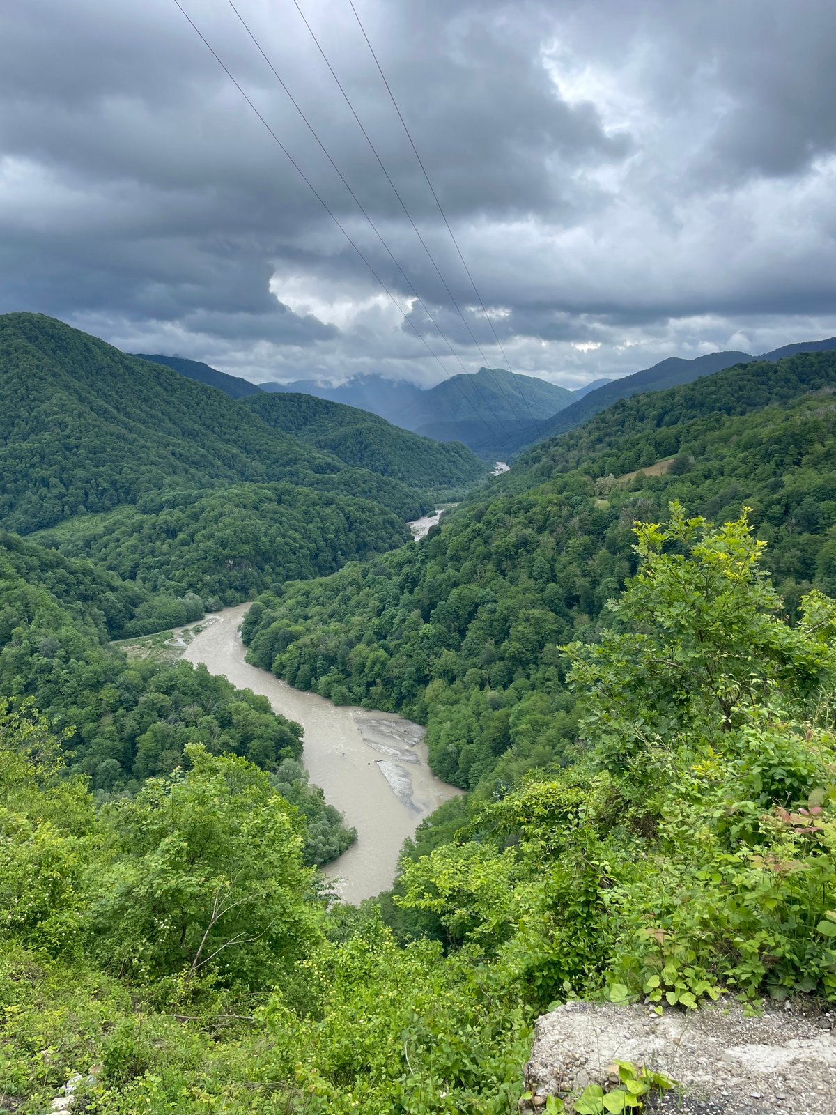 Tourist documents mountain adventure at Russian scenic viewpoint