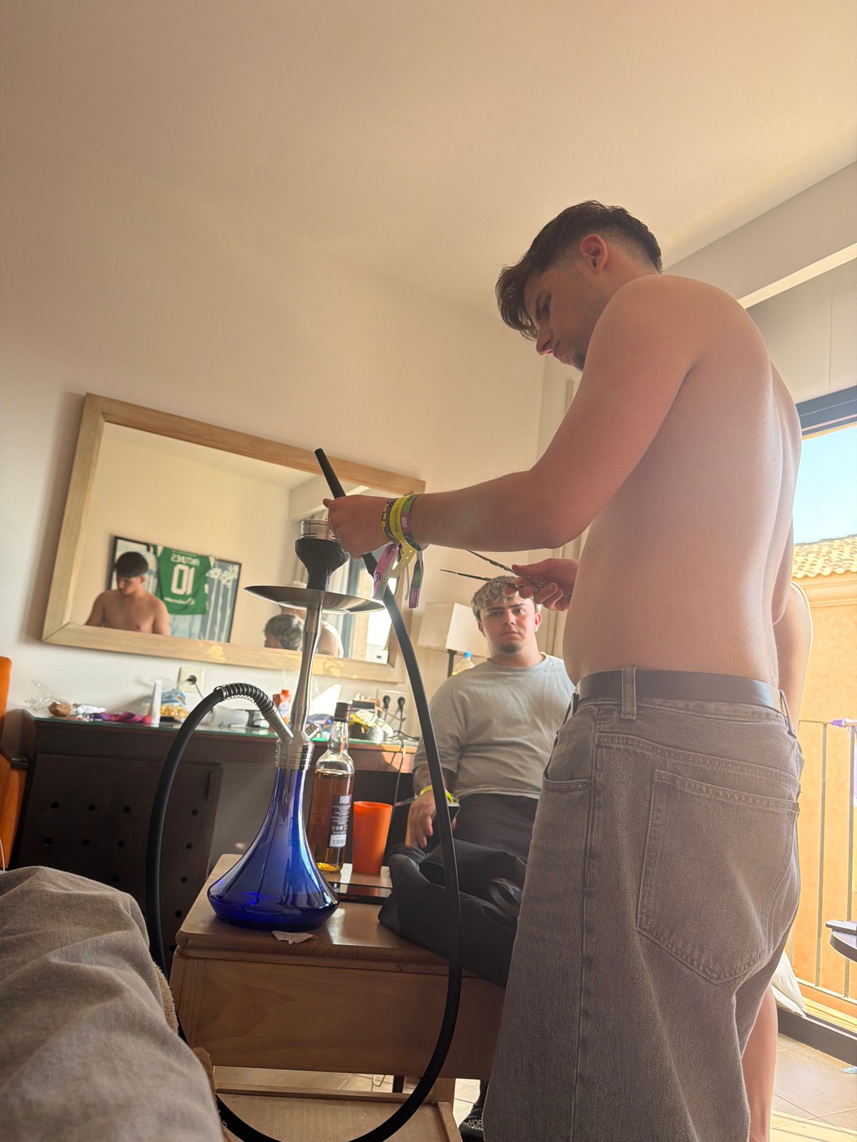 Group gathers indoors in Punta Umbría, hookah setup observed