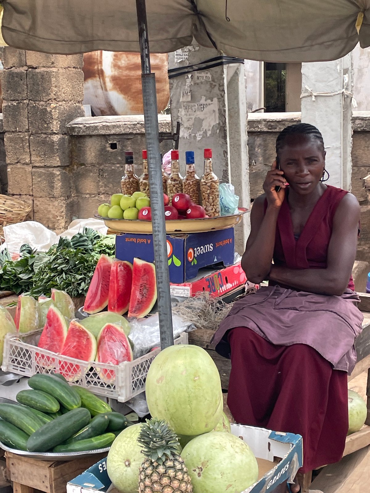 Woman vendor operates produce stall at Jos market
