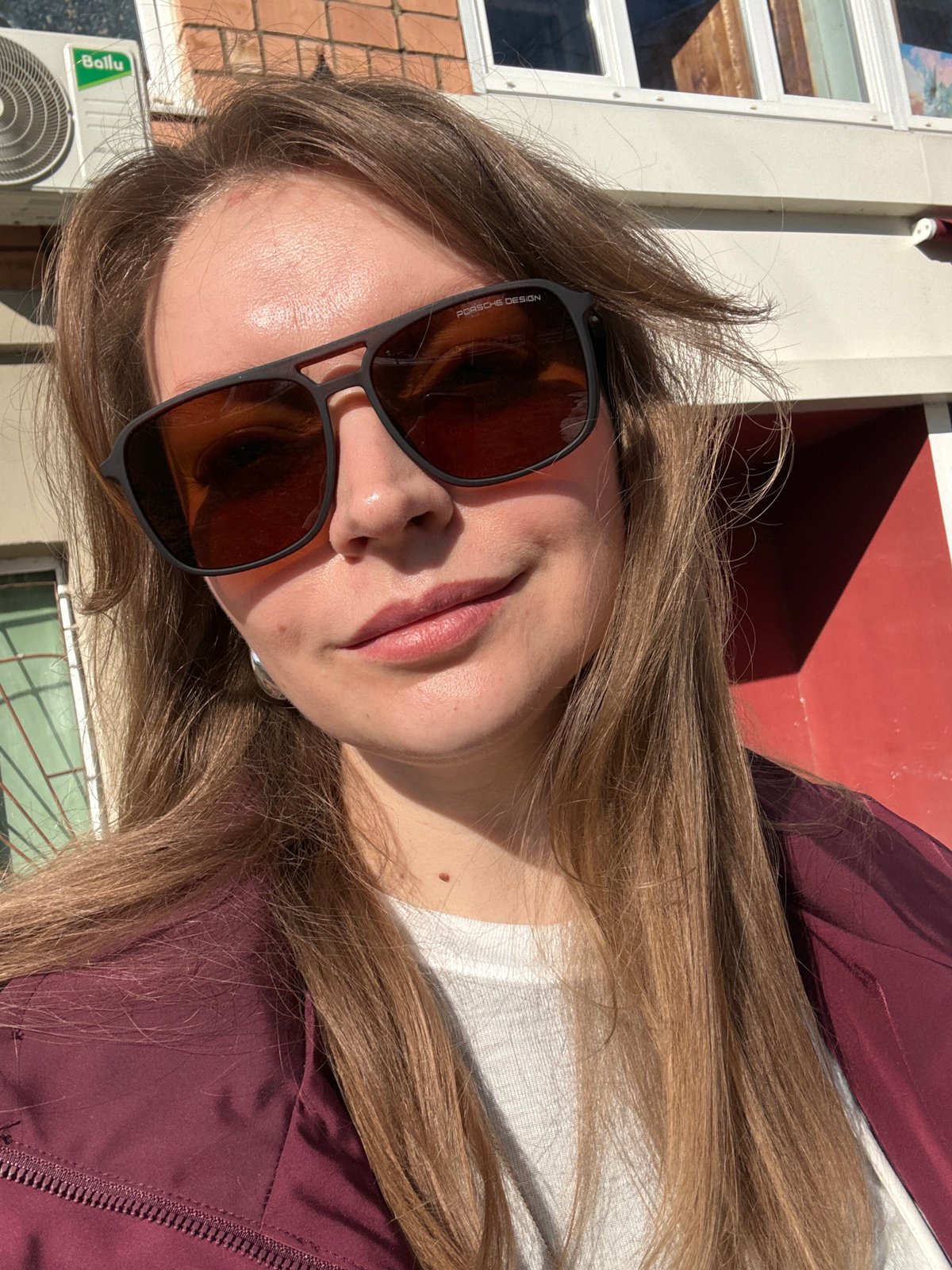 Woman in burgundy jacket photographed outdoors in Izhevsk