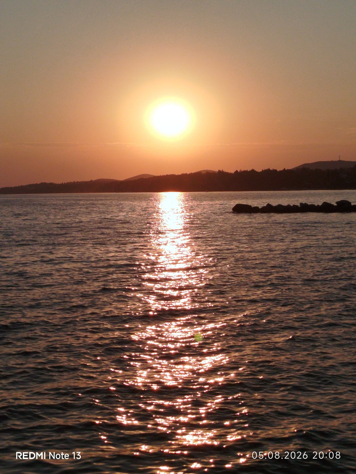 Sunset evening on a Sithonian beach, fishing and swimming.