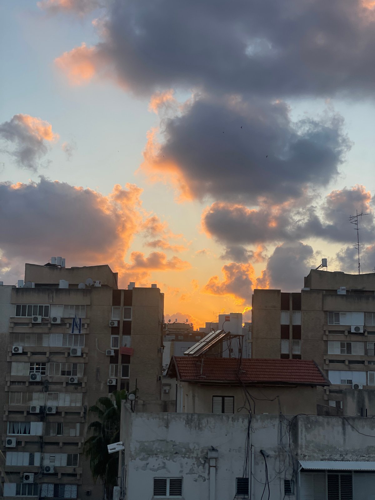 Sunset captured over Petah Tikva buildings amid evening observations