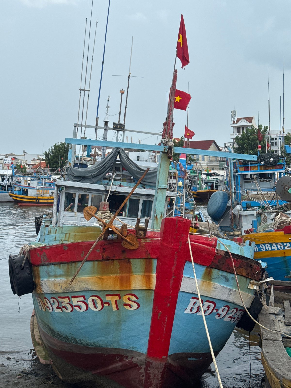 Phan Thiết fishing fleet packed into harbor under stormy skies