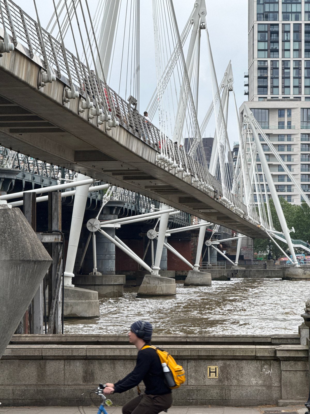 Tourist documents London landmarks walk near Thames bridges