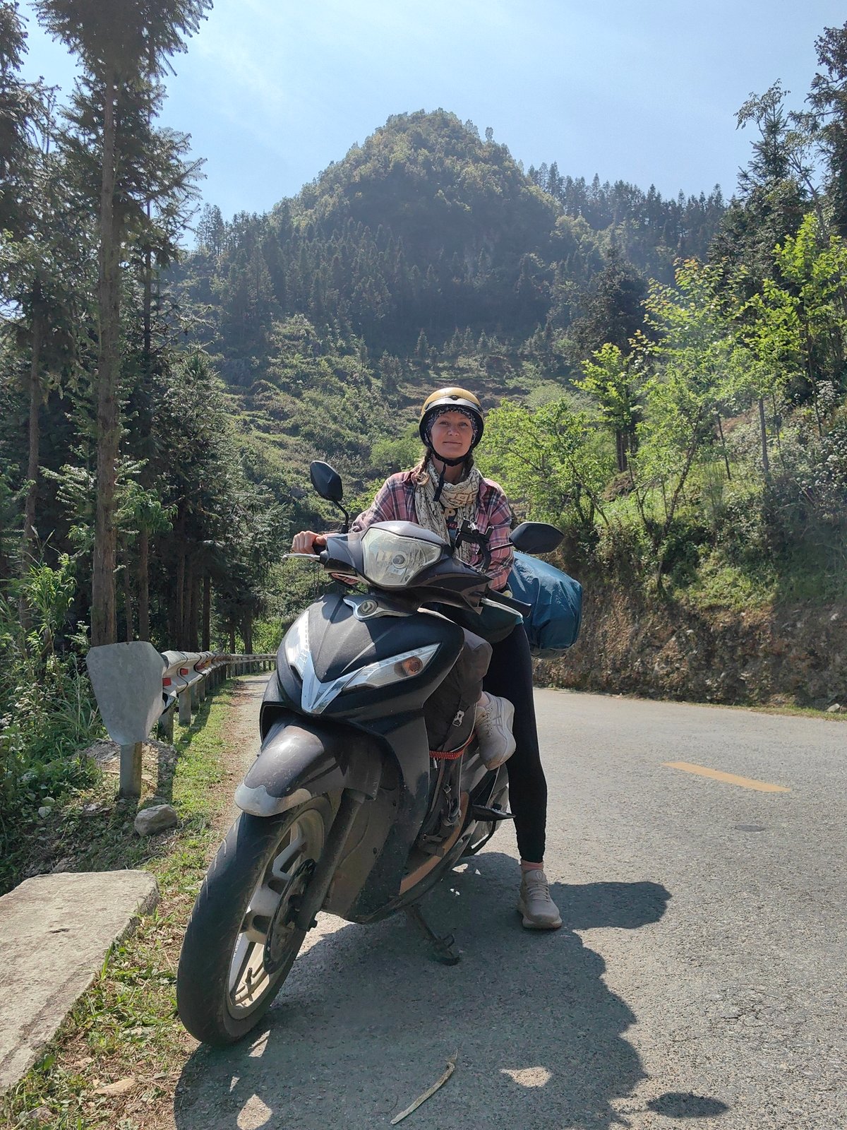 Scooter rider photographed in scenic Lũng Cú mountain commune