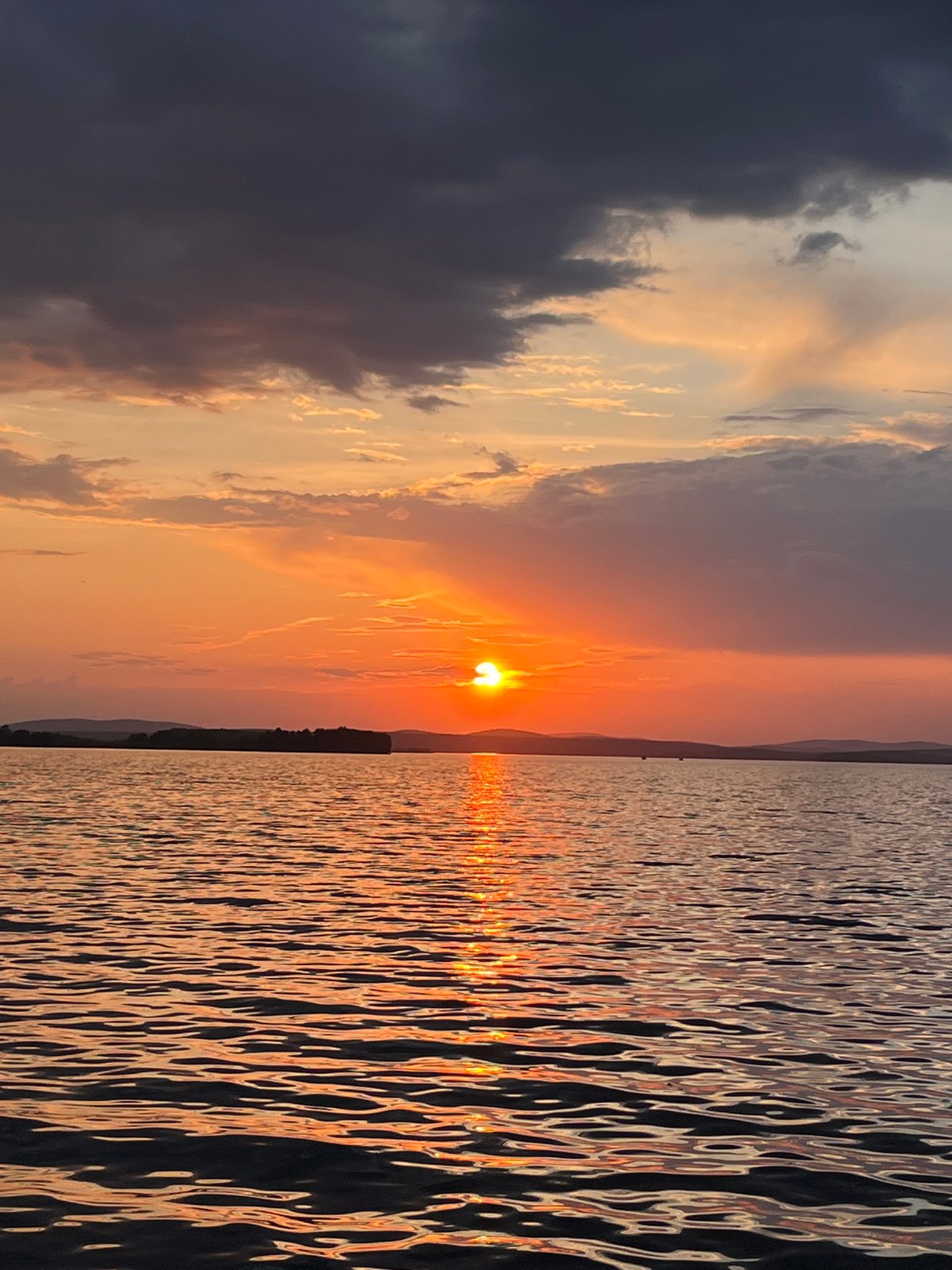 Sunset gathering captured along Yekaterinburg waterfront with romantic gestures