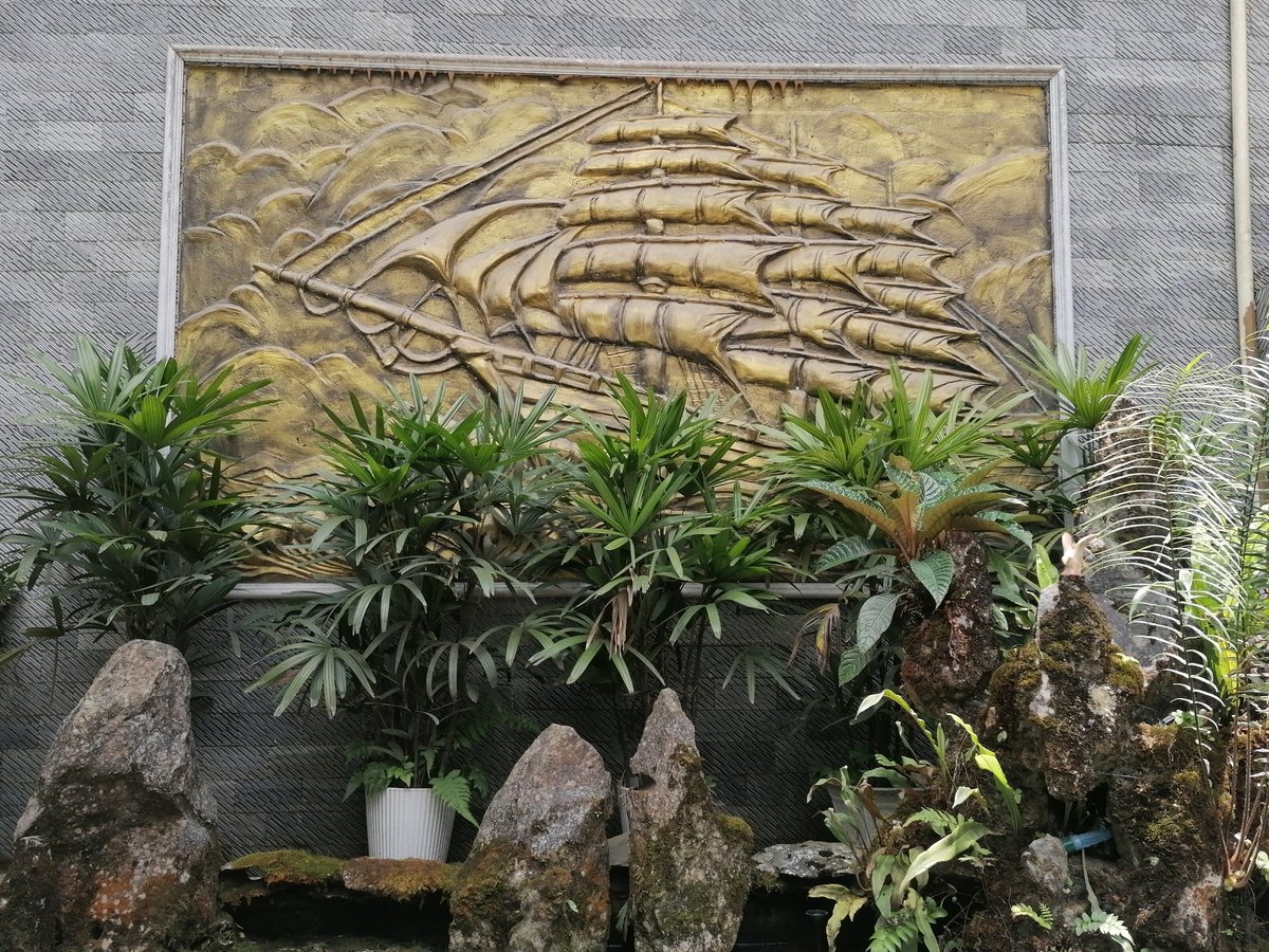 Garden with golden ship sculpture and koi pond observed in Sa Pa