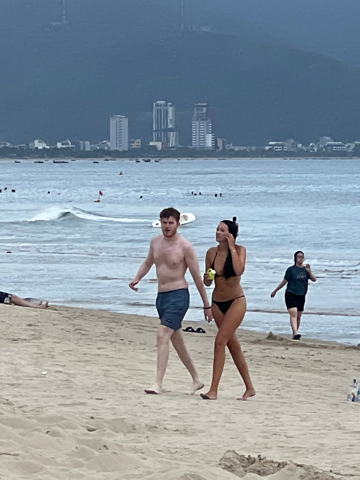 Busy morning at Da Nang beach, swimmers and sunbathers out early