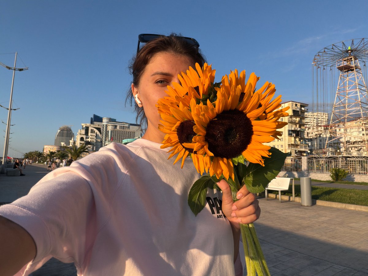 Sunflower bouquet photoshoot along Batumi's waterfront promenade