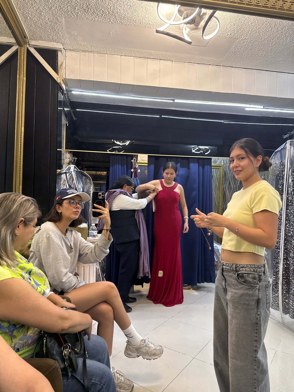 Woman tries on red dress at Puebla shop
