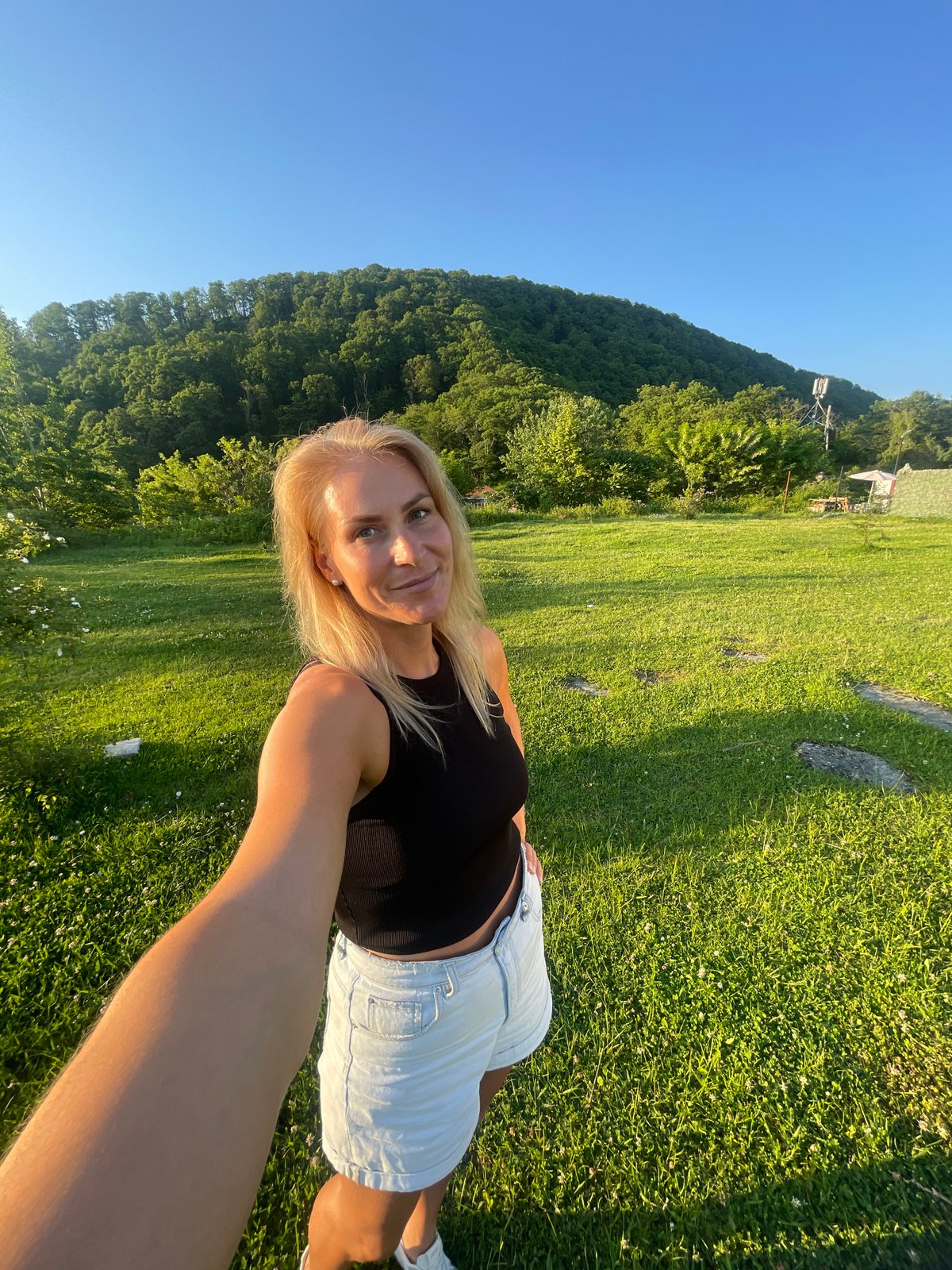 Woman photographs herself at scenic Russian coastal locations