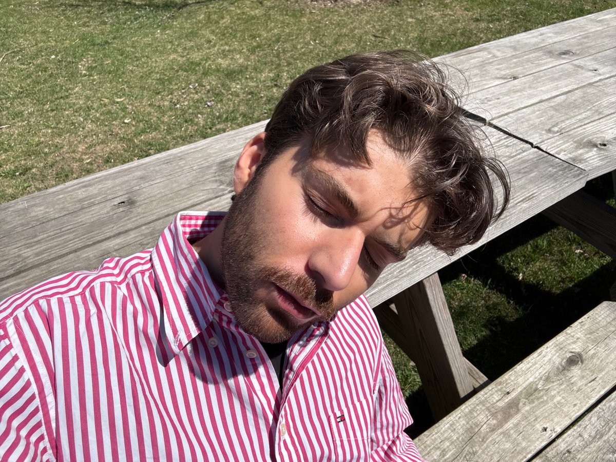 Man rests on picnic table in Montreal park