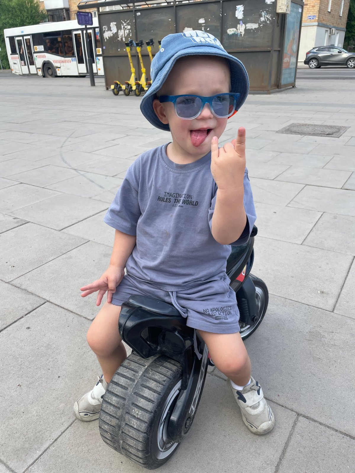 Child plays on toy motorcycle in Krasnoyarsk