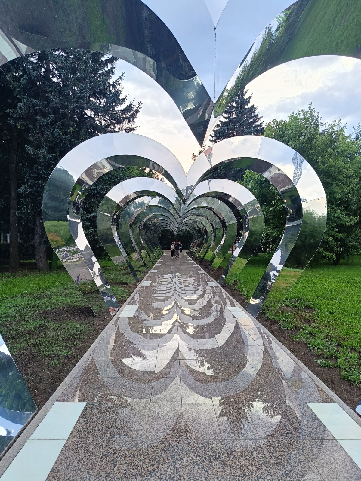 Park tunnel, lit sculpture, and city transit across one evening