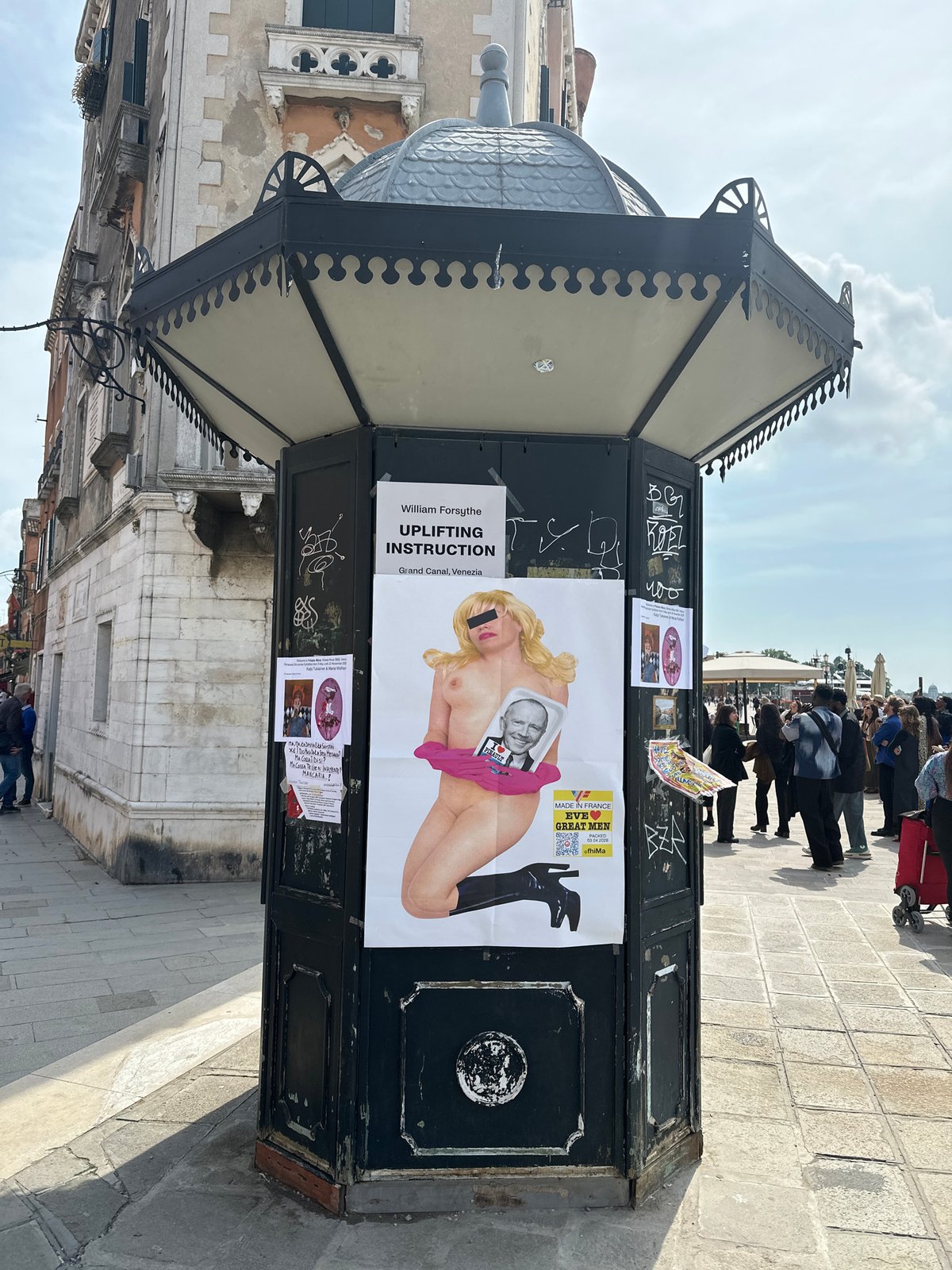 Vandalized ornate kiosk documented in Venice with graffiti, posters