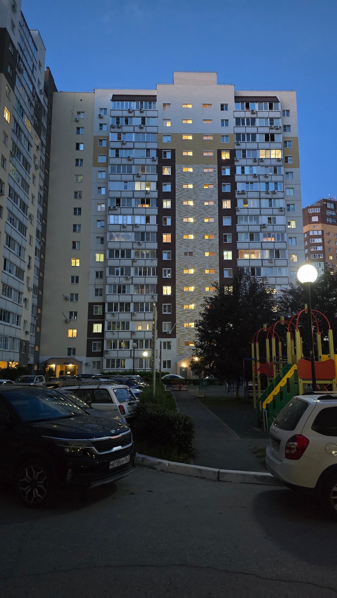 Tolyatti apartment blocks at dusk, one sitting waterside