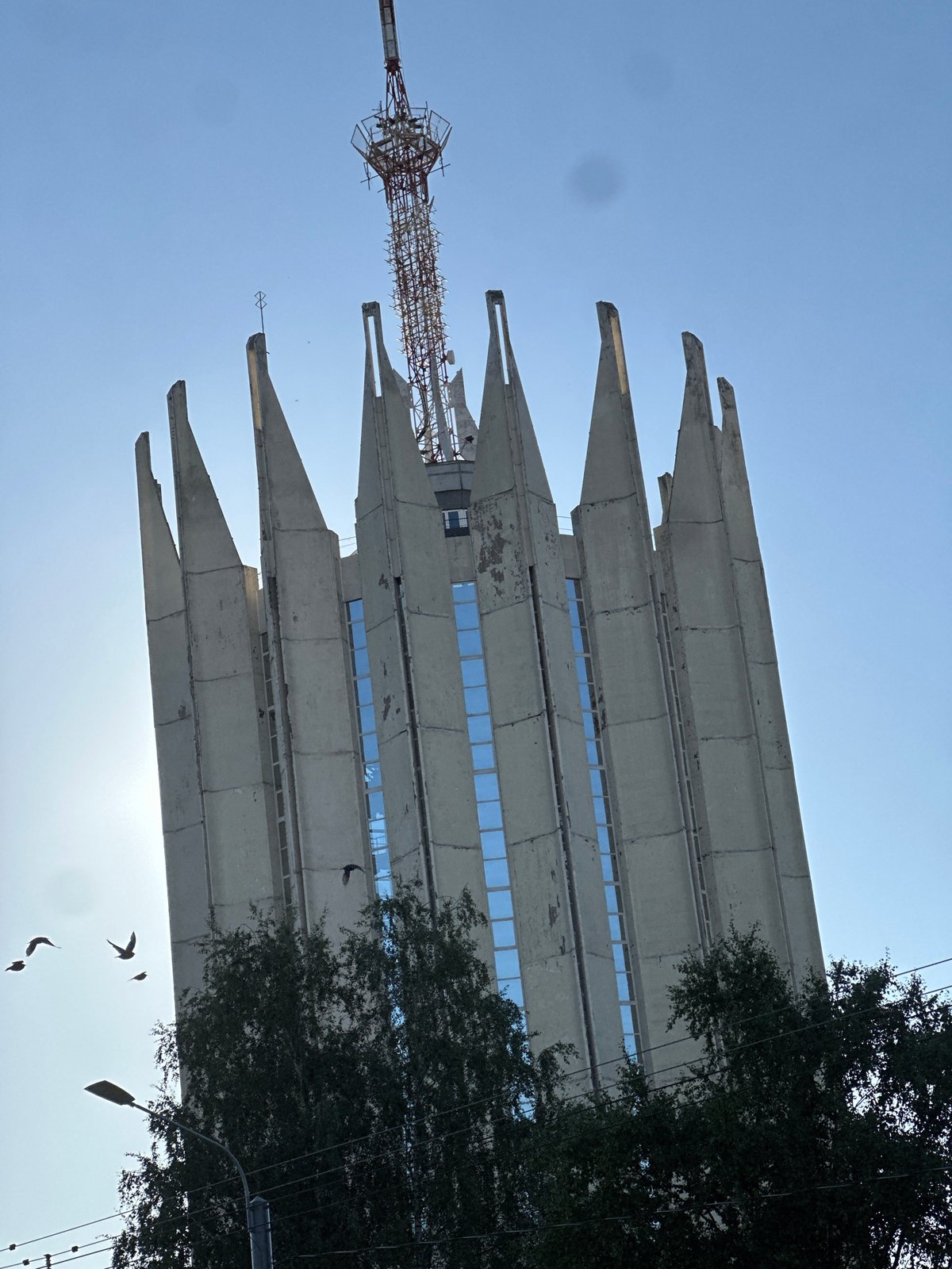 Brutalist concrete tower with angular crown, Russia