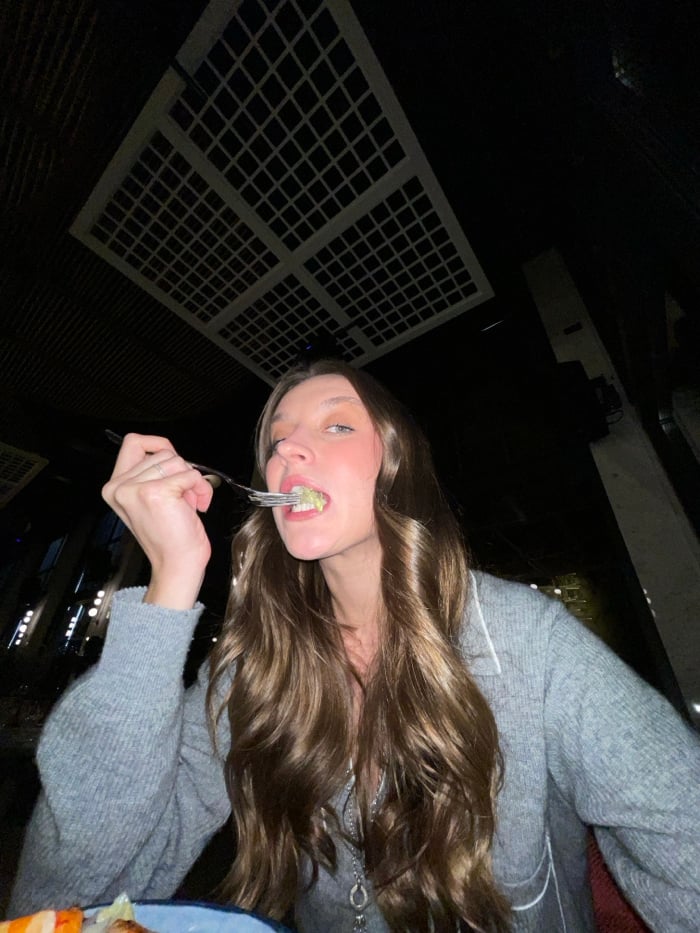 Woman documents dinner and selfies at Budva restaurant-club